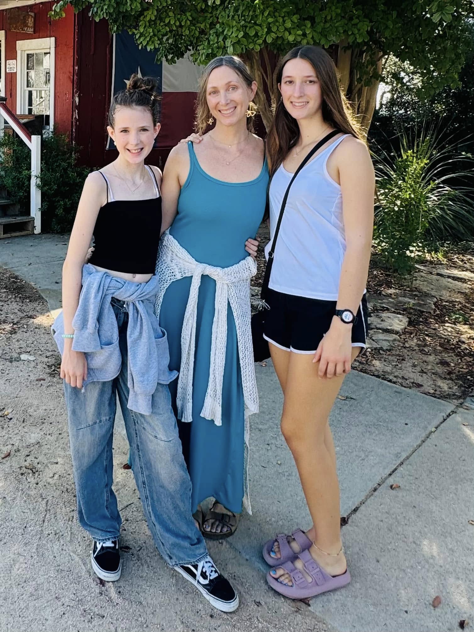 Surya, Liz and Malaya Hammond smiling in a paved yard. From a post dated September 19, 2024. | Source: Facebook/elizabeth.m.hammond