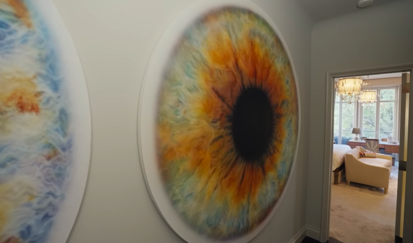 The hallway functions almost like a mini-gallery. Even the path between rooms has been turned into a visual moment. | Source: YouTube/Architectural Digest