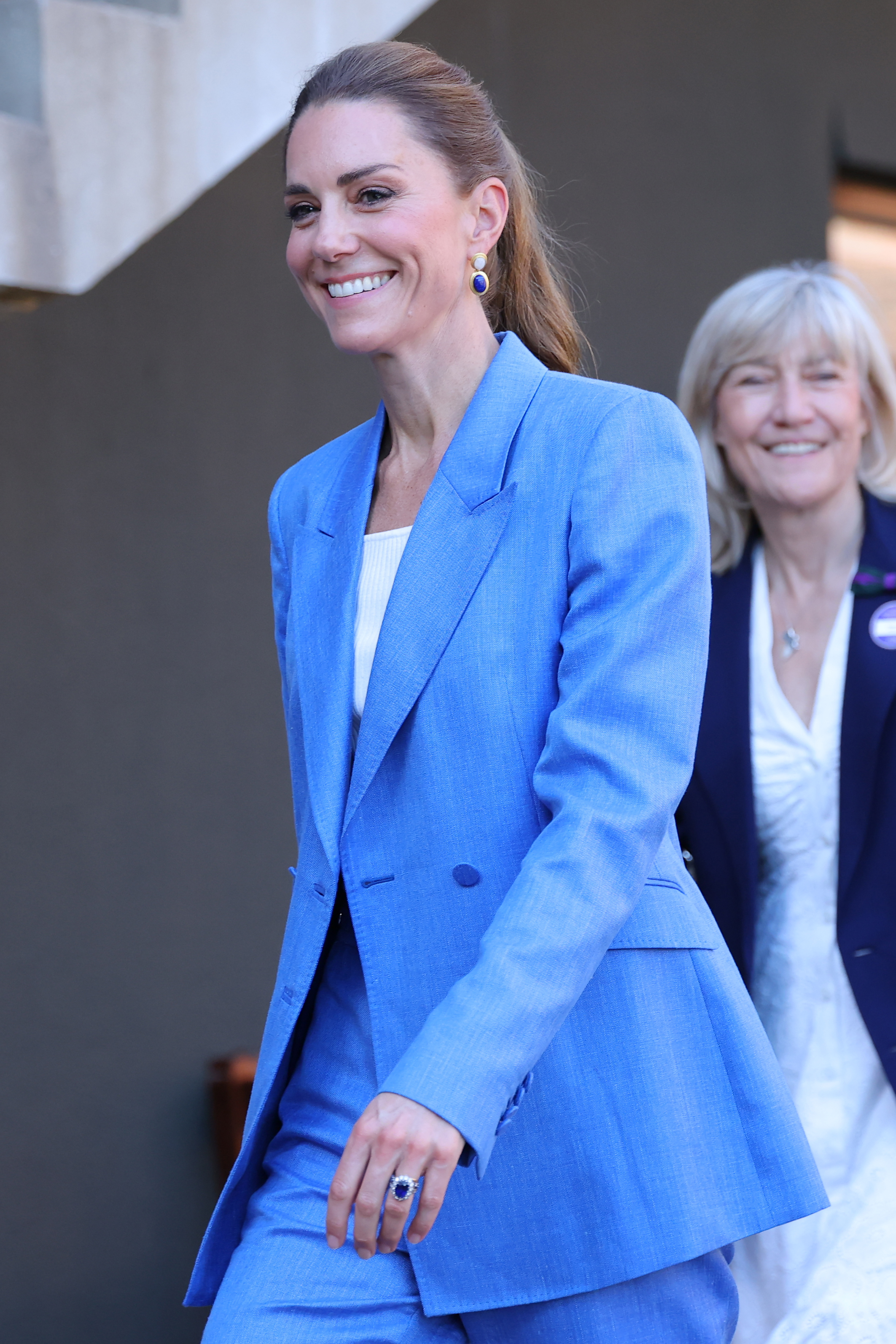 Catherine wore her hair in a wavy ponytail, a noticeable change from the loose waves she often favors at Wimbledon. The hairstyle complemented the modern tailoring of her blue suit. | Source: Getty Images