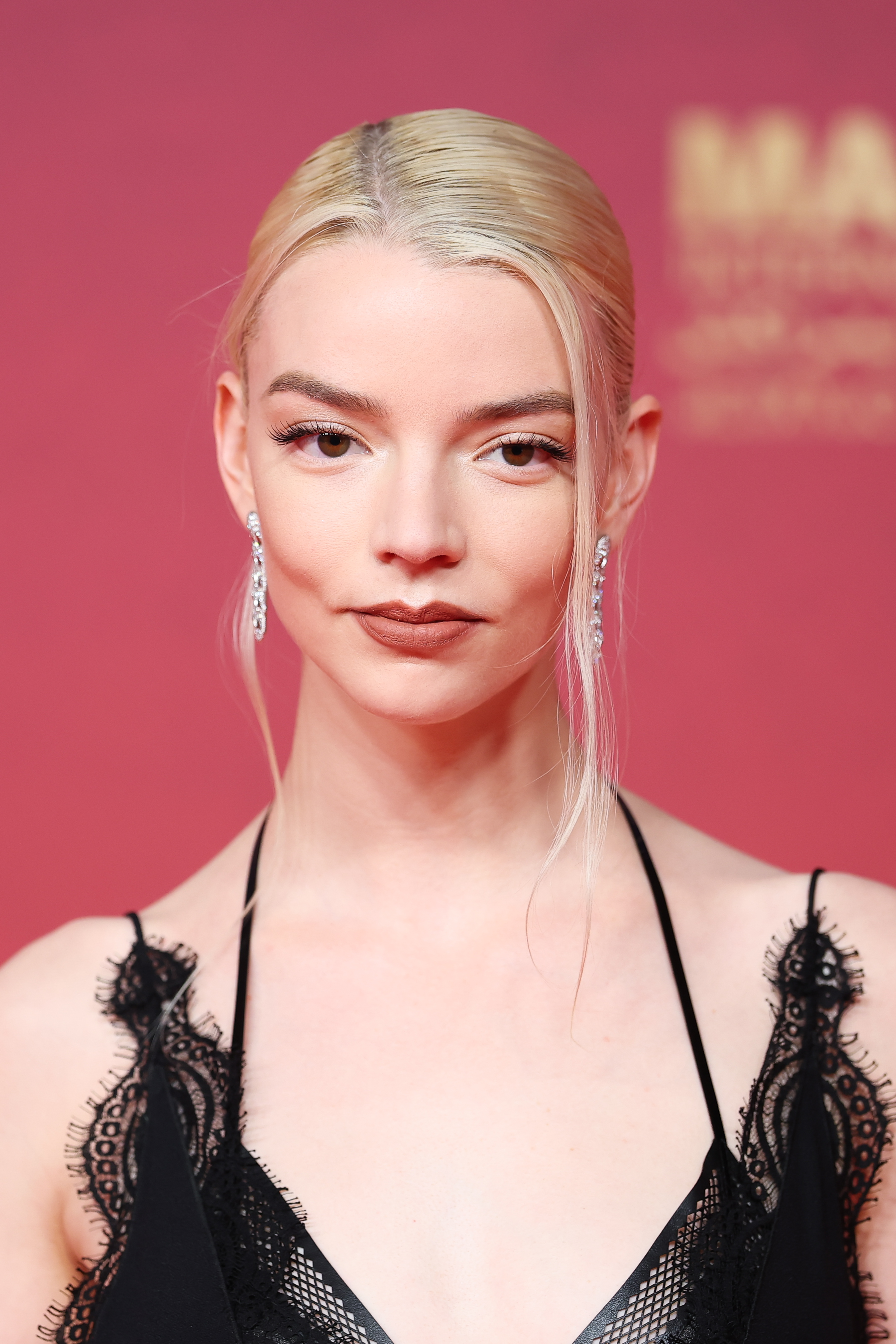 Anya Taylor-Joy attends a closing red carpet event in Marrakech, posing against a soft pink backdrop | Source: Getty Images