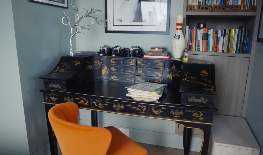 Sophia's room mixes polished design with unmistakably personal objects, including cameras and stacks of books. The elaborate black-and-gold desk adds an unexpected old-world touch to an otherwise contemporary space. | Source: YouTube/Architectural Digest