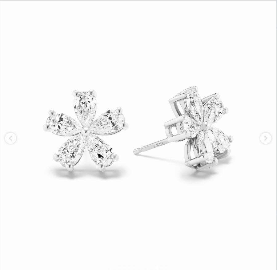 Bruss-Lee's ceremony earrings featured five pear-shaped diamonds arranged in a delicate floral silhouette, echoing the flower details of her custom wedding gown. | Source: Instagram/