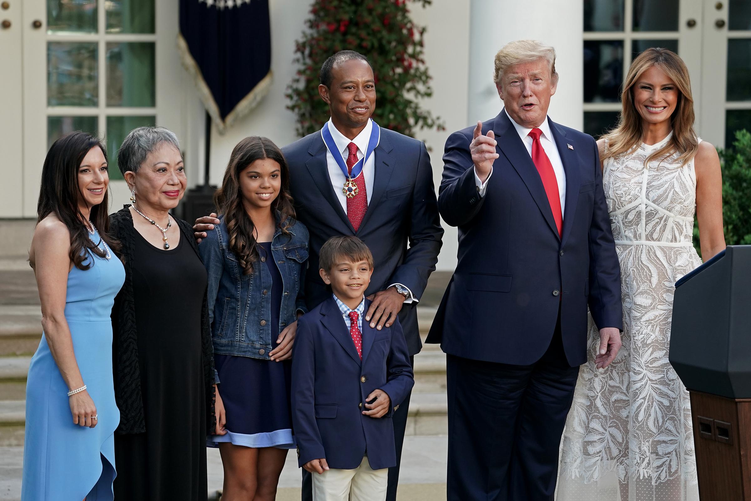 Erica Herman, Kultida Woods, Sam Alexis Woods, Charlie Axel Woods, Tiger Woods, Donald Trump, and Melania Trump pose for photographs after Tiger Woods was presented with the Medal of Freedom during a ceremony in the Rose Garden at the White House on May 6, 2019, in Washington, DC | Source: Getty Images