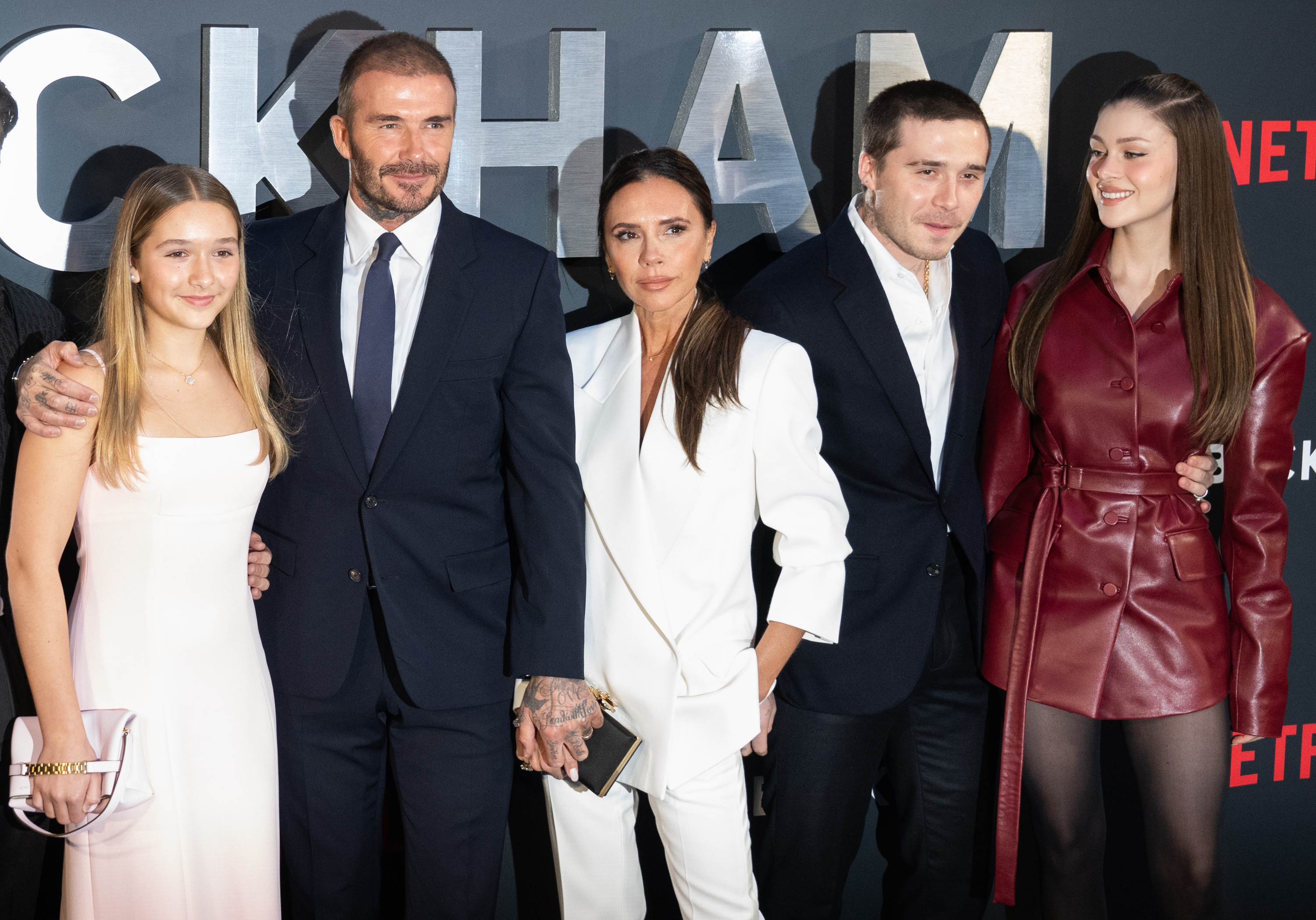 Harper, David, Victoria, and Brooklyn Beckham with Nicola Peltz at the UK Premiere of "Beckham." | Source: Getty Images