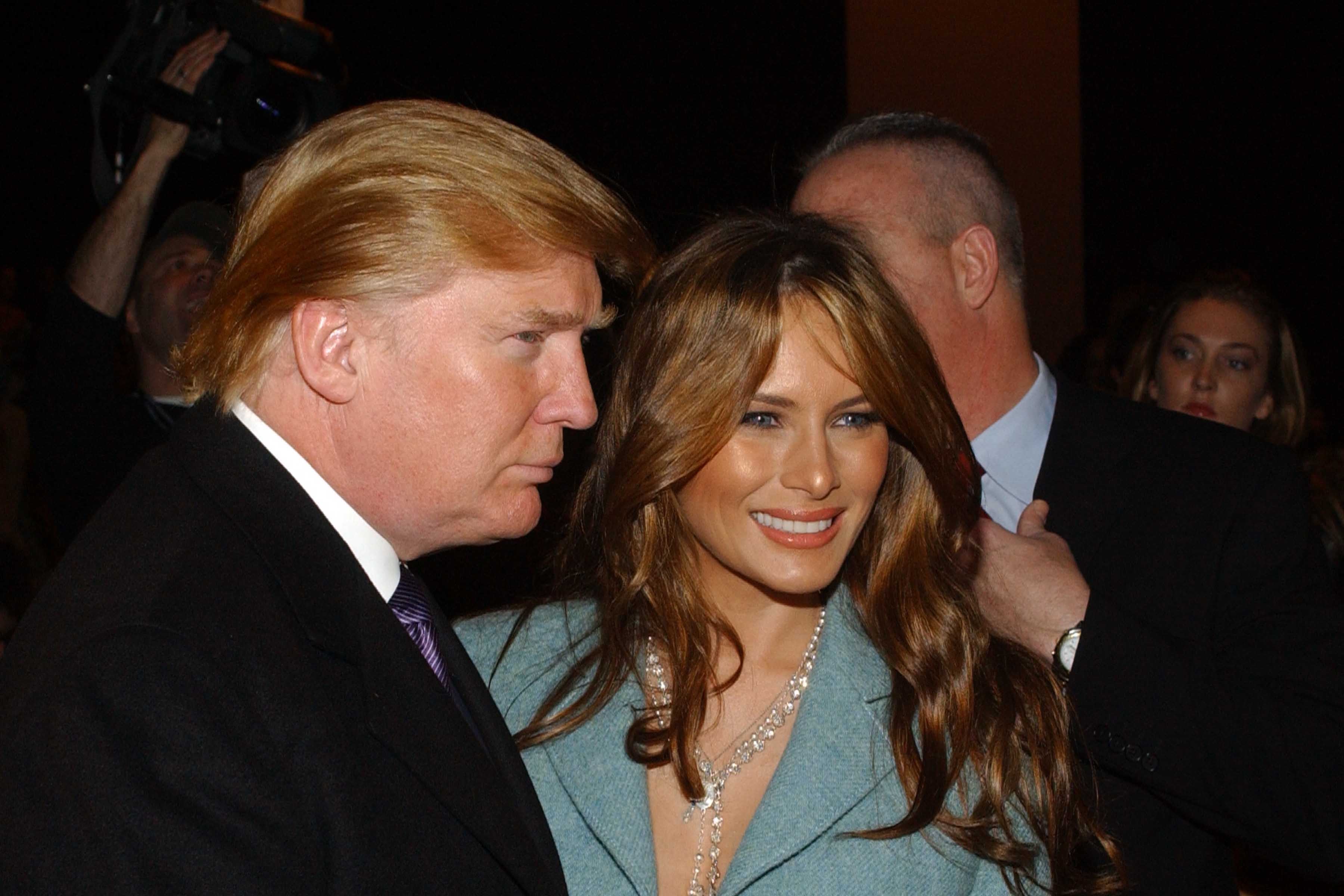 Donald Trump's hair has shifted to a distinctly golden-blond shade by 2005, as he attends the Michael Kors Fall fashion show with Melania Trump in New York City on February 9.