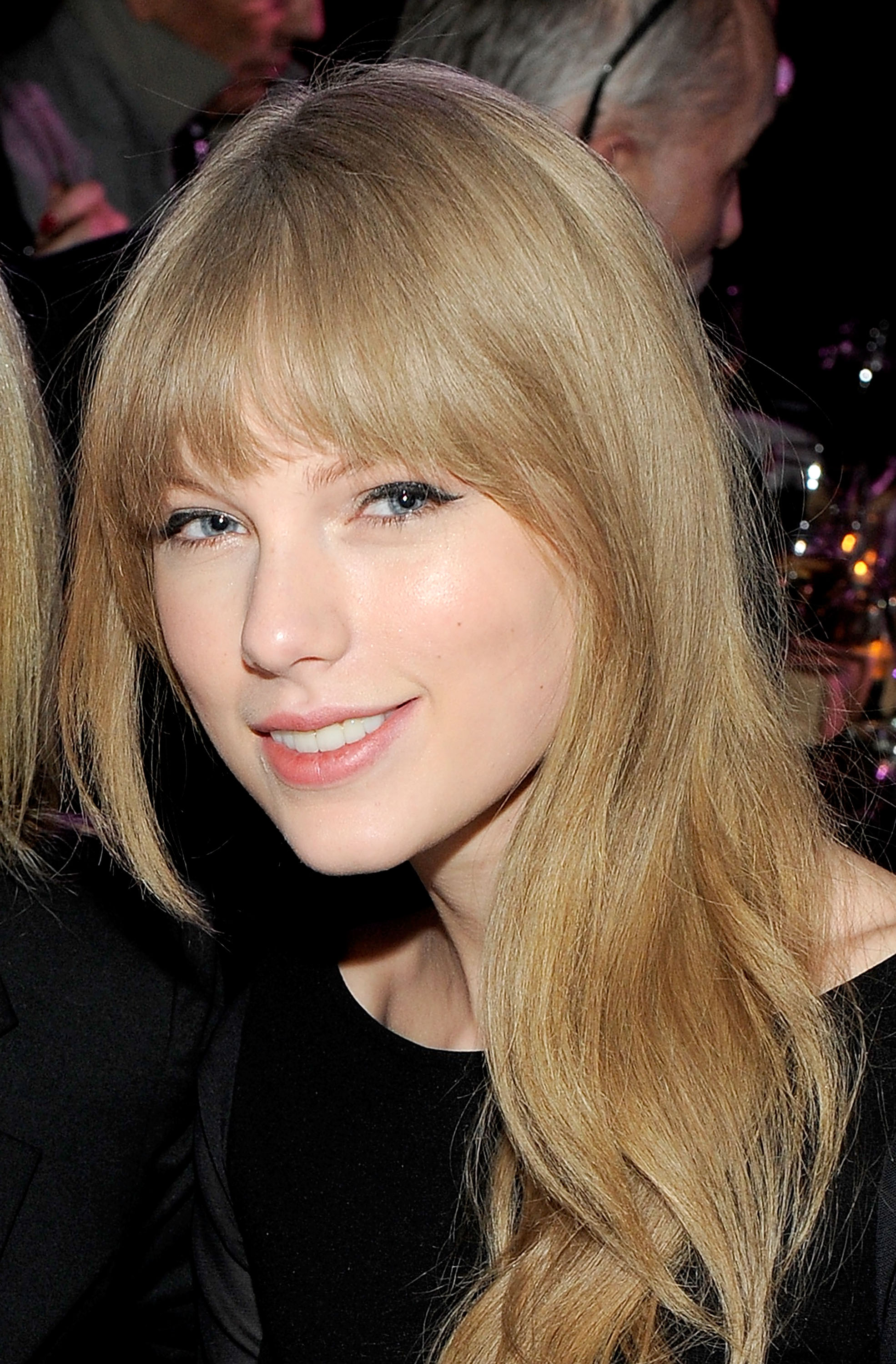 Now in her early twenties, Taylor Swift turns heads at the Artist at the Table Dinner and Discussion, held at The Shop during the Sundance Film Festival in Park City, Utah. She wears a slight smile, and her hairstyle now features a fringe, marking a fresh change in her look.