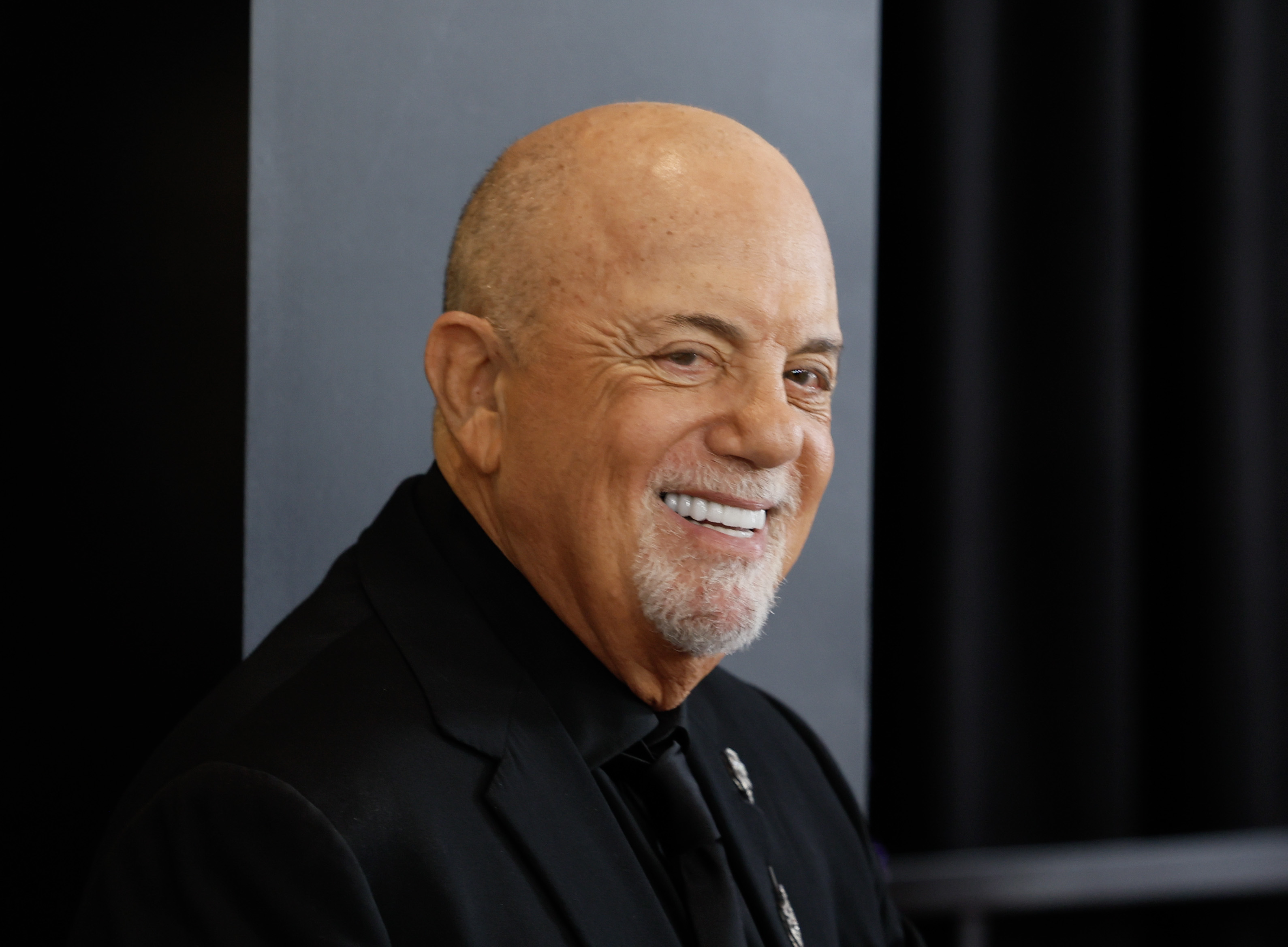 Billy Joel arrives at the 66th Grammy Awards in Los Angeles on Feb. 4, 2024. He recently reassured fans about his health after revealing that he underwent surgery to have a shunt implanted. | Source: Getty Images