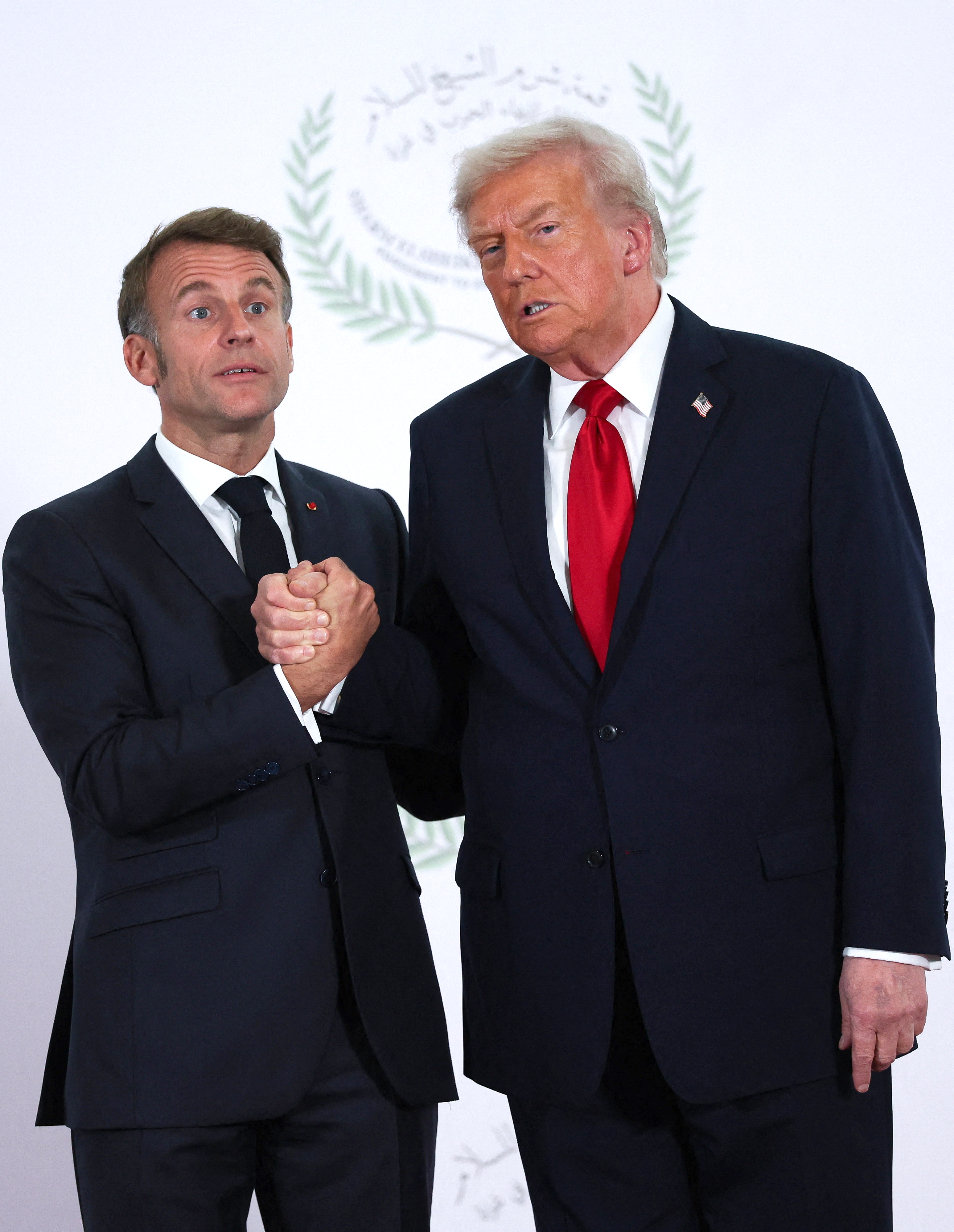President Donald Trump greets French President Emmanuel Macron during the summit in Sharm El-Sheikh, Egypt on October 13, 2025 | Source: Getty Images