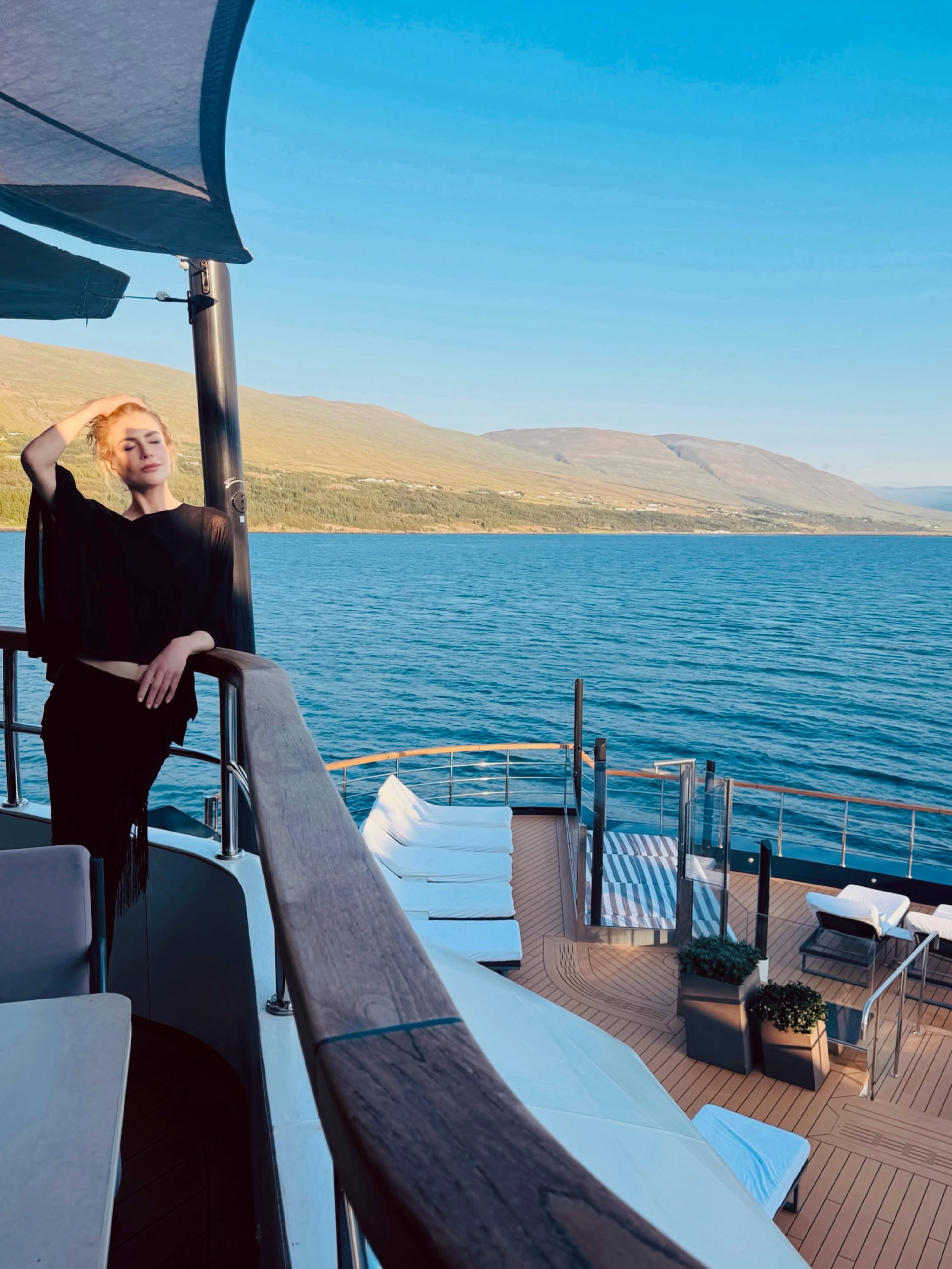 Basking in the Icelandic atmosphere, Nicole strikes a pose on an upper deck surrounded by scenic fjords. Dressed in an all-black outfit, she enjoyed high-seas views aboard the luxury vessel. | Source: Instagram/nicolekidman