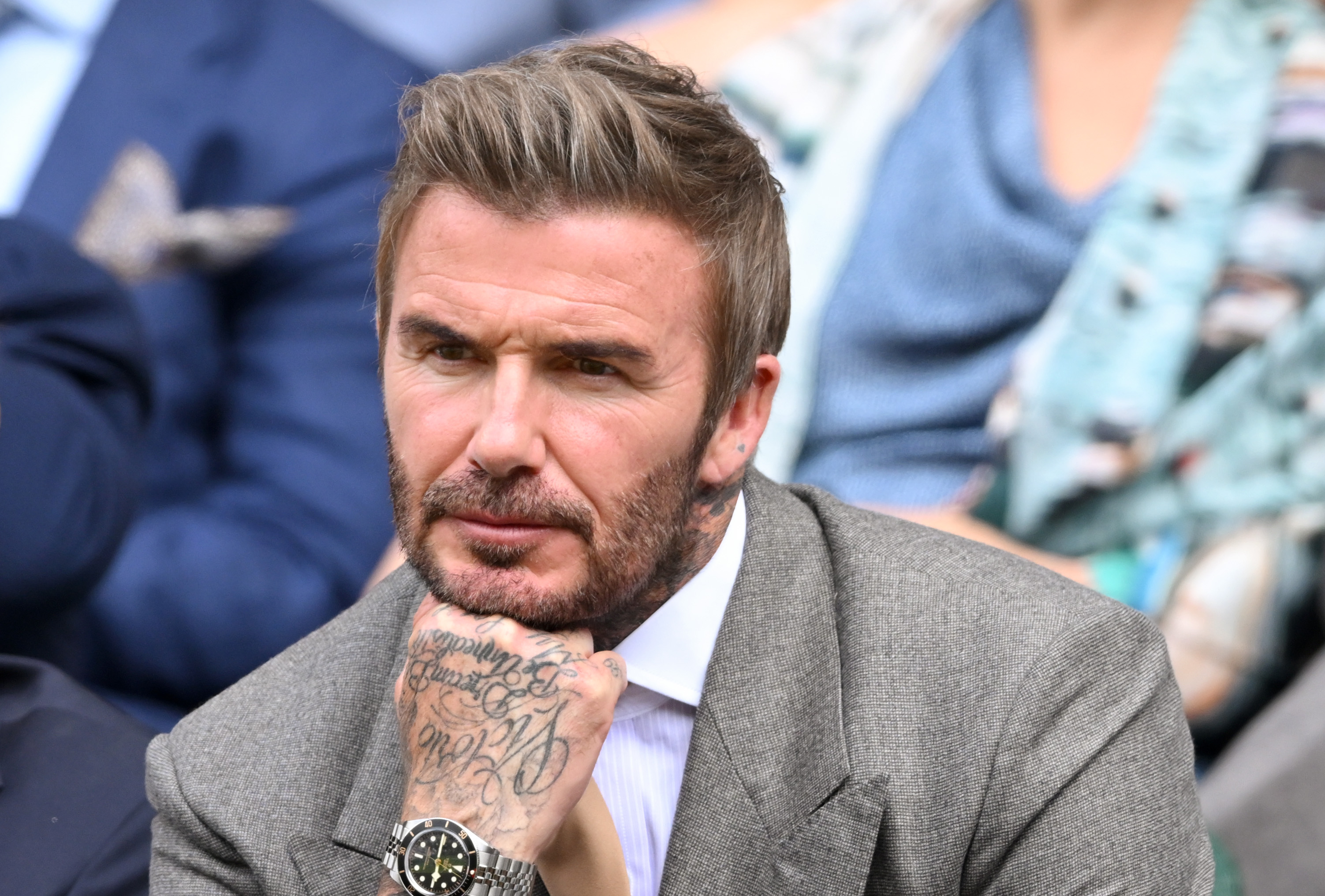 David's casual Portofino wardrobe was a departure from his more formal public style. At Wimbledon in June 2026, he swapped vacation T-shirts and shorts for a gray suit and white shirt. | Source: Getty Images