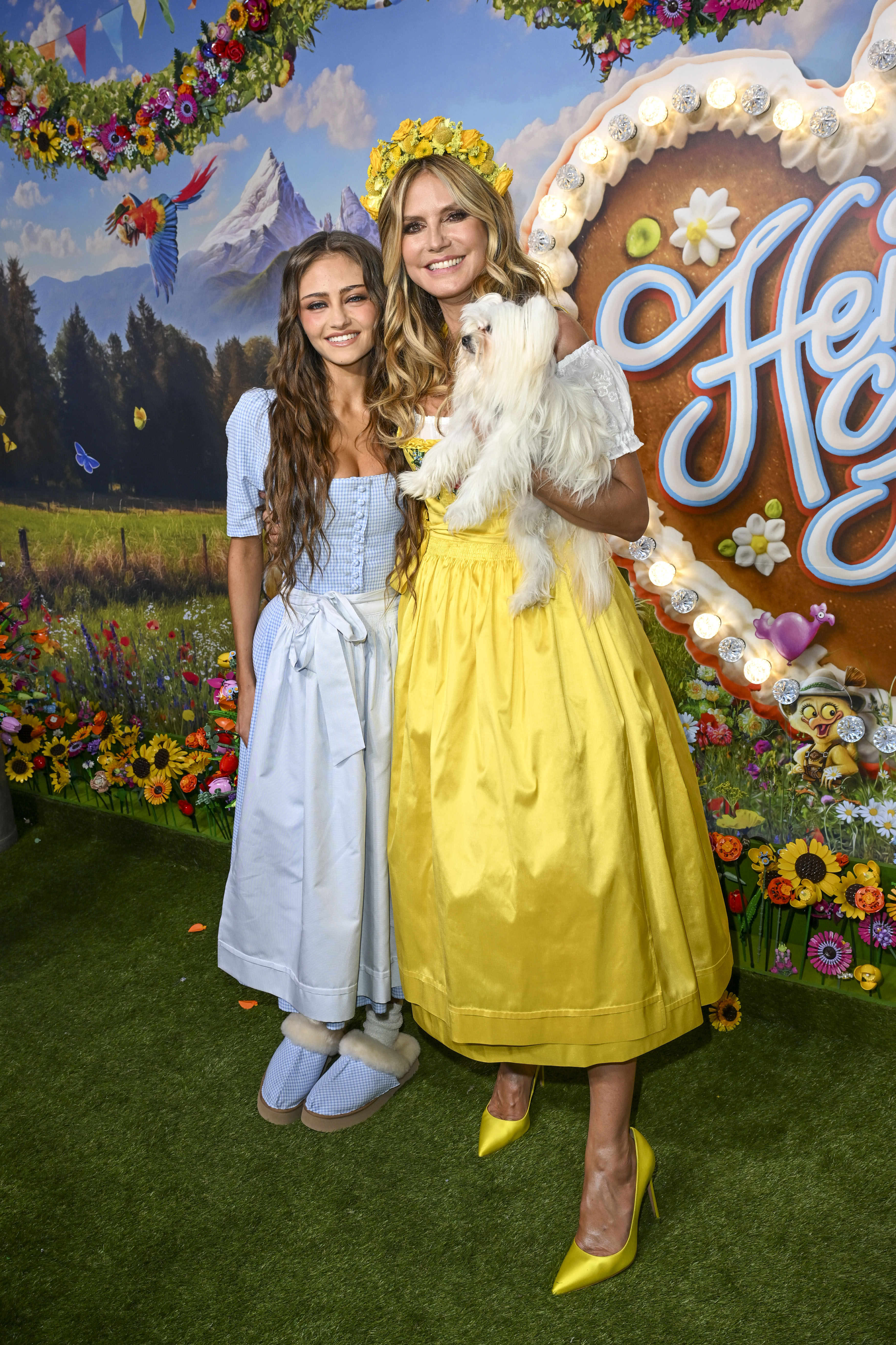 Heidi Klum and Leni Klum pose together at the “HeidiFest by Heidi Klum” ahead of the 2026 Oktoberfest at Hofbräuhaus Munich on September 17, 2026, in Munich, Germany. Heidi holds her dog while wearing a yellow dirndl and matching floral crown. | Source: Getty Images