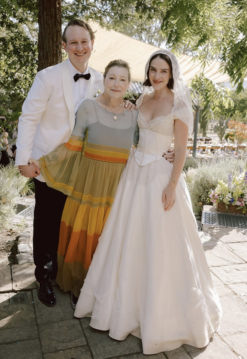 Tatum O'Neal posed with newlyweds Kevin McEnroe and Fern Cozine on their wedding day. Fern wore a custom Cinq gown with a hooded veil, accessorized with gold and diamond earrings gifted by John McEnroe and Patty Smyth the night before the ceremony. | Source: Instagram/@tatum__oneal