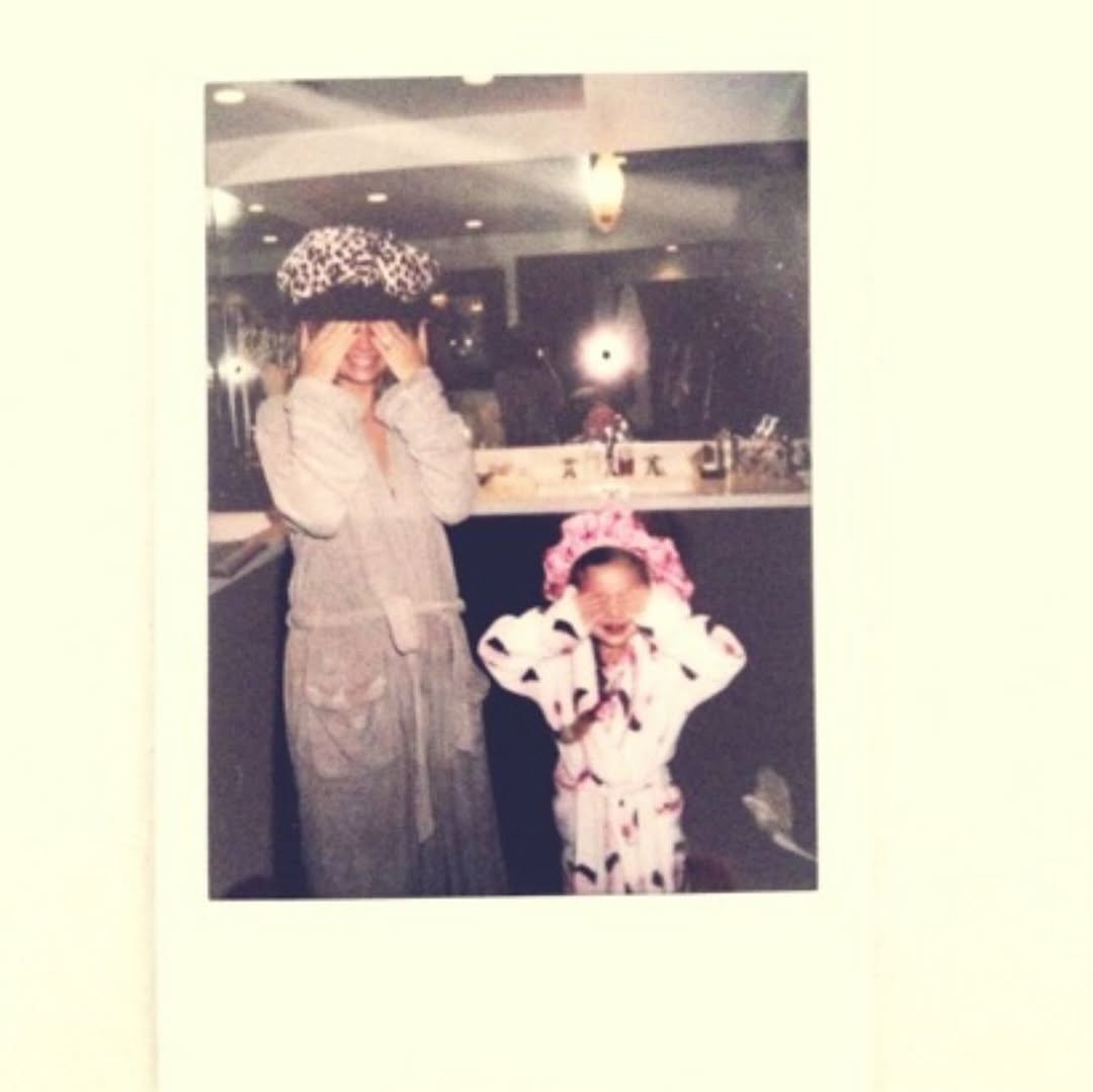Nicole Richie and young Harlow Winter Kate Madden pose in a playful Polaroid-style snapshot indoors. Both cover their faces while wearing dress-up hats, capturing a lighthearted mother-daughter moment from Kate's childhood. | Source: Instagram/nicolerichie and joelmadden