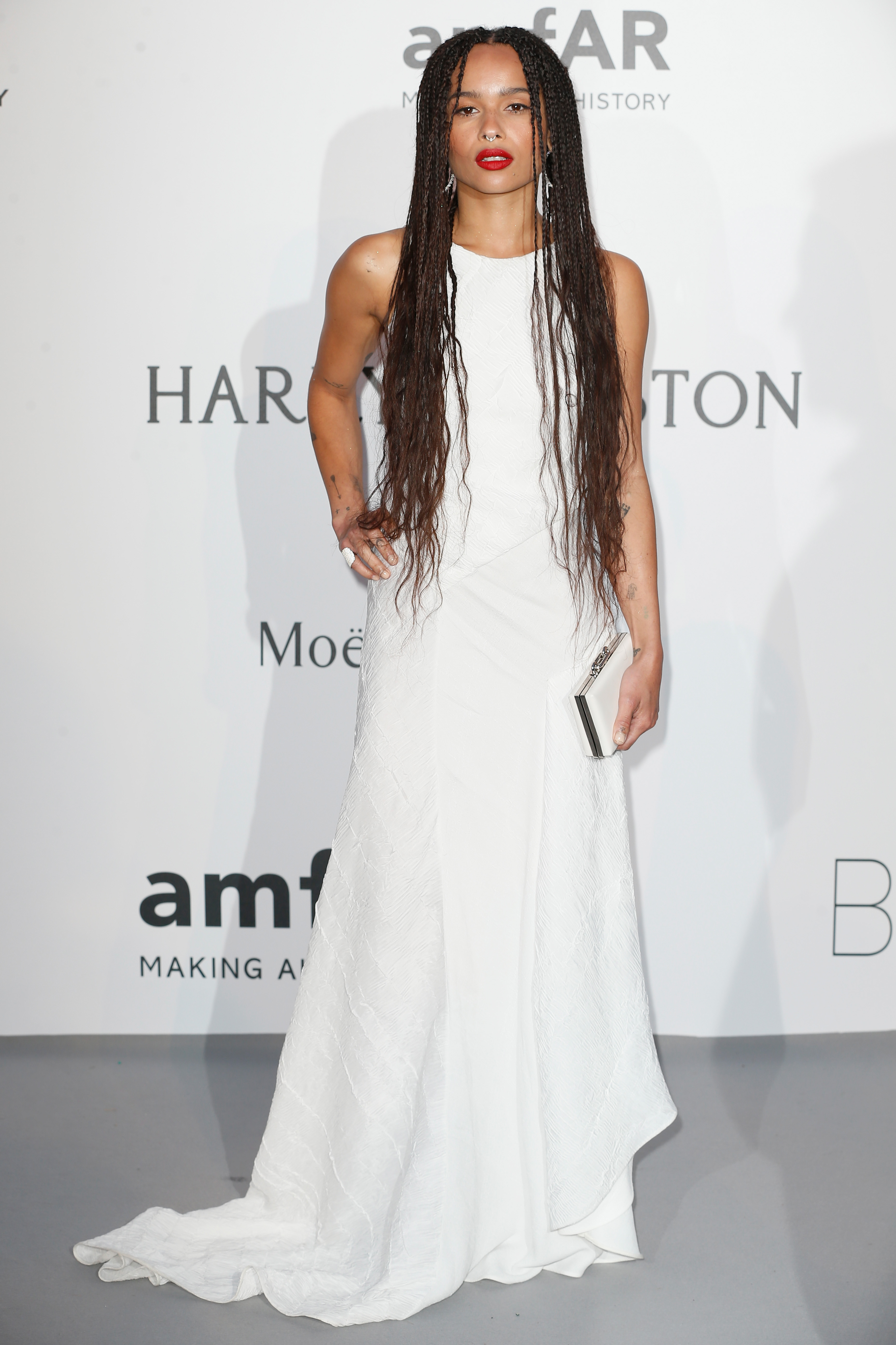 Zoë Kravitz attended amfAR's 22nd Cinema Against AIDS Gala at Hotel du Cap-Eden-Roc in Cap d’Antibes, France, on May 21. She wore a sleeveless textured white gown with a subtle train, paired with long braids, a white clutch, and a bold red lip.