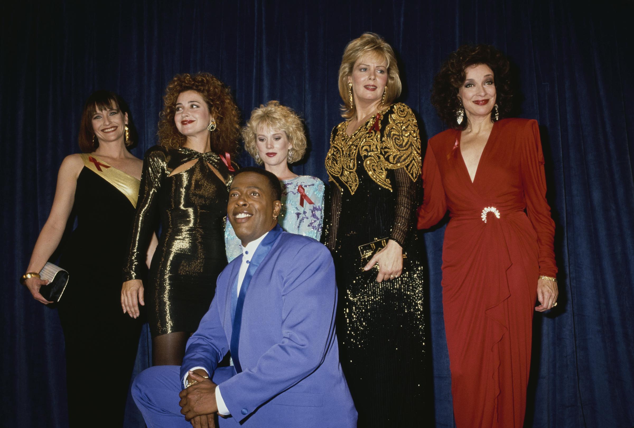 The cast of CBS sitcom Designing Women — Jan Hooks, Annie Potts, Julia Duffy, Meshach Taylor, Jean Smart, and Dixie Carter—poses in the press room of the 43rd Annual Primetime Emmy Awards at the Pasadena Civic Auditorium in Pasadena, California, on August 25, 1991. | Source: Getty Images