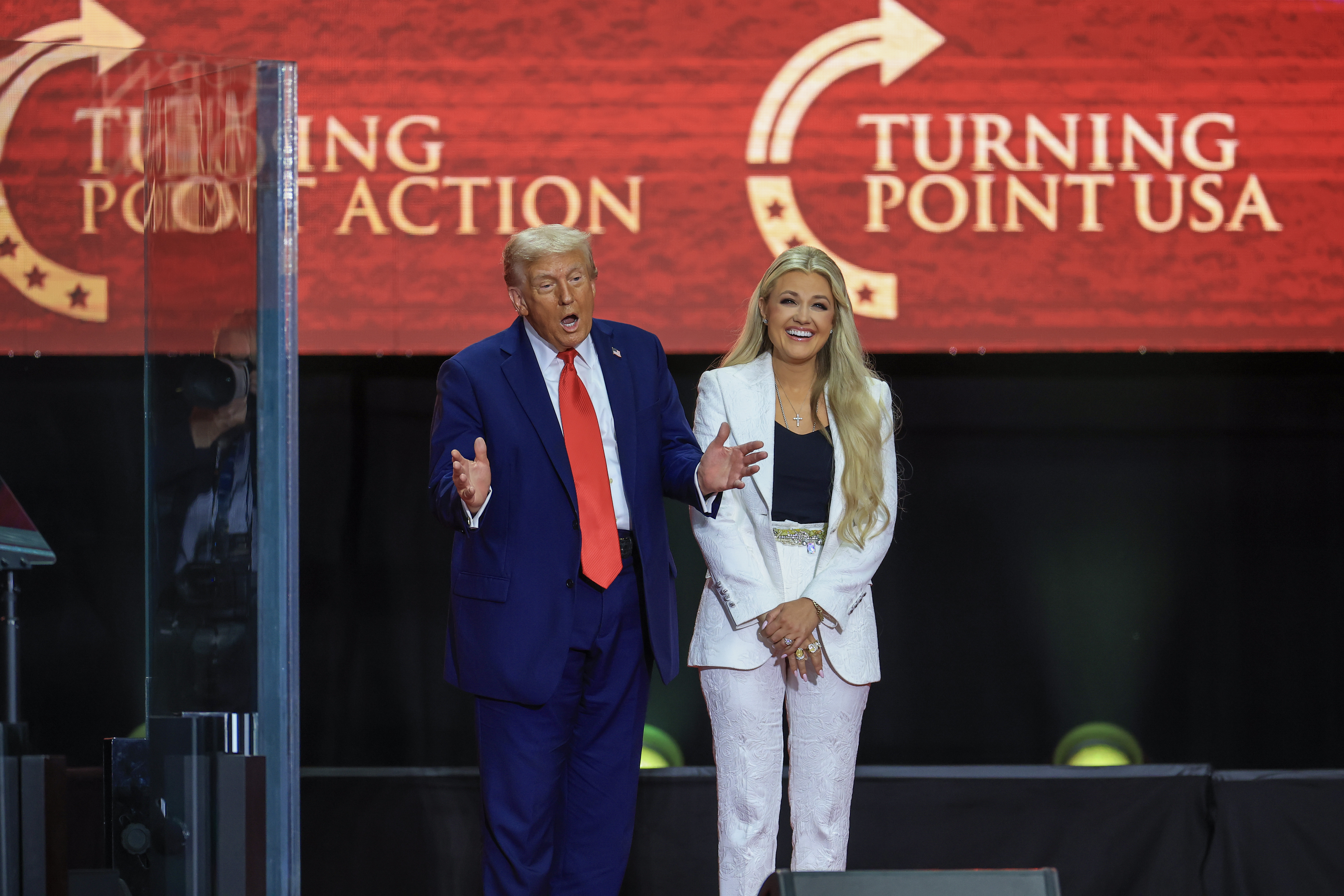U.S. President Donald Trump speaking as Erika Kirk smiles beside him. | Source: Getty Images