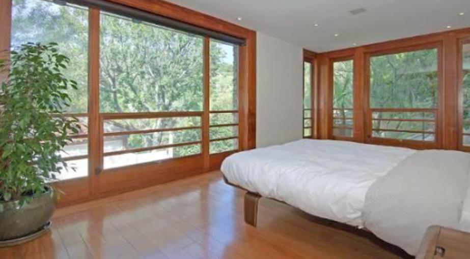 The Los Feliz house carried its wood-heavy architectural language into the private spaces as well. Trulia reported that the primary suite also included separate closets and bathrooms.