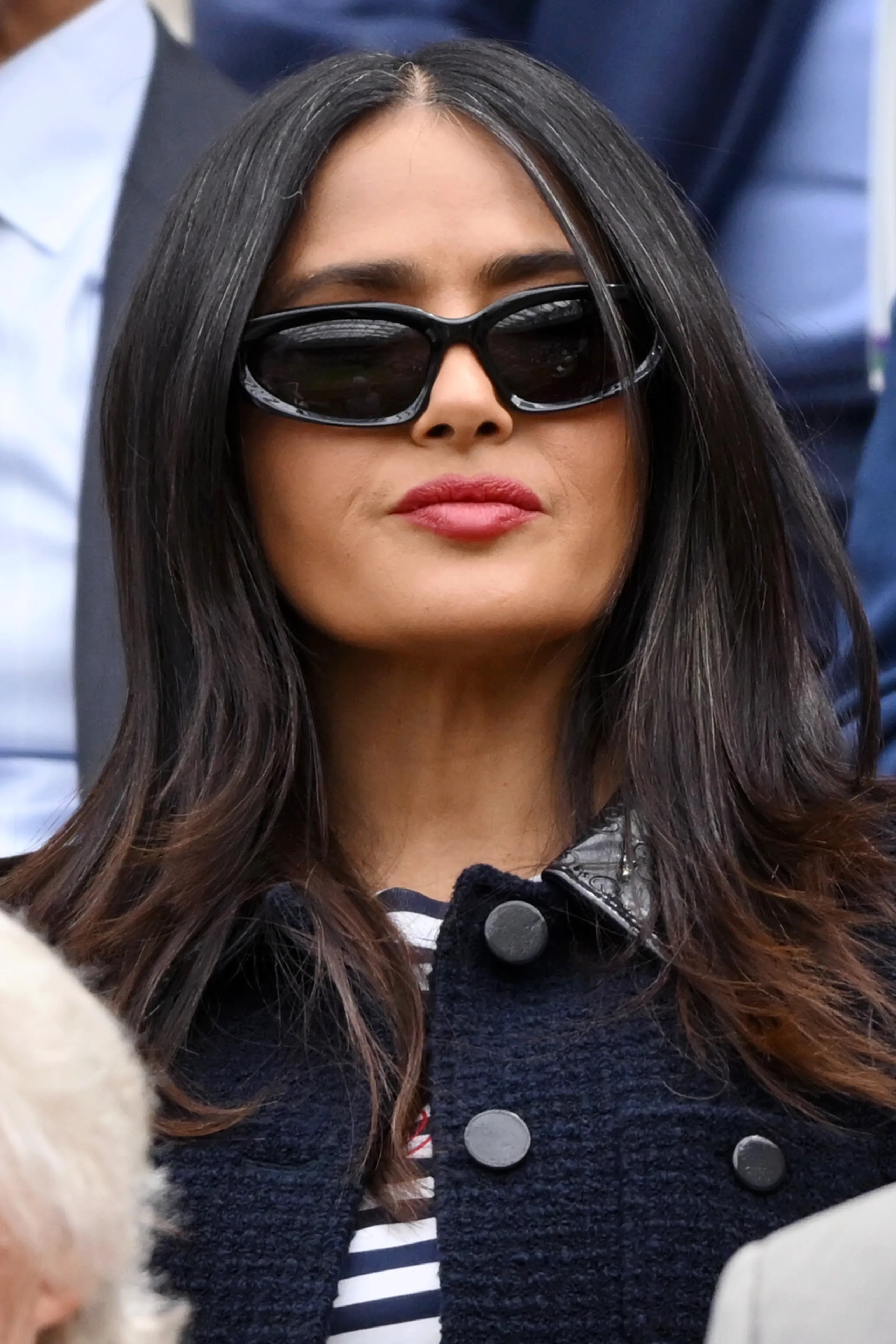 Salma Hayek's natural silver strands were clearly visible among her dark brunette hair at Wimbledon, where she embraced the gray rather than hiding it for the cameras. | Source: Getty Images