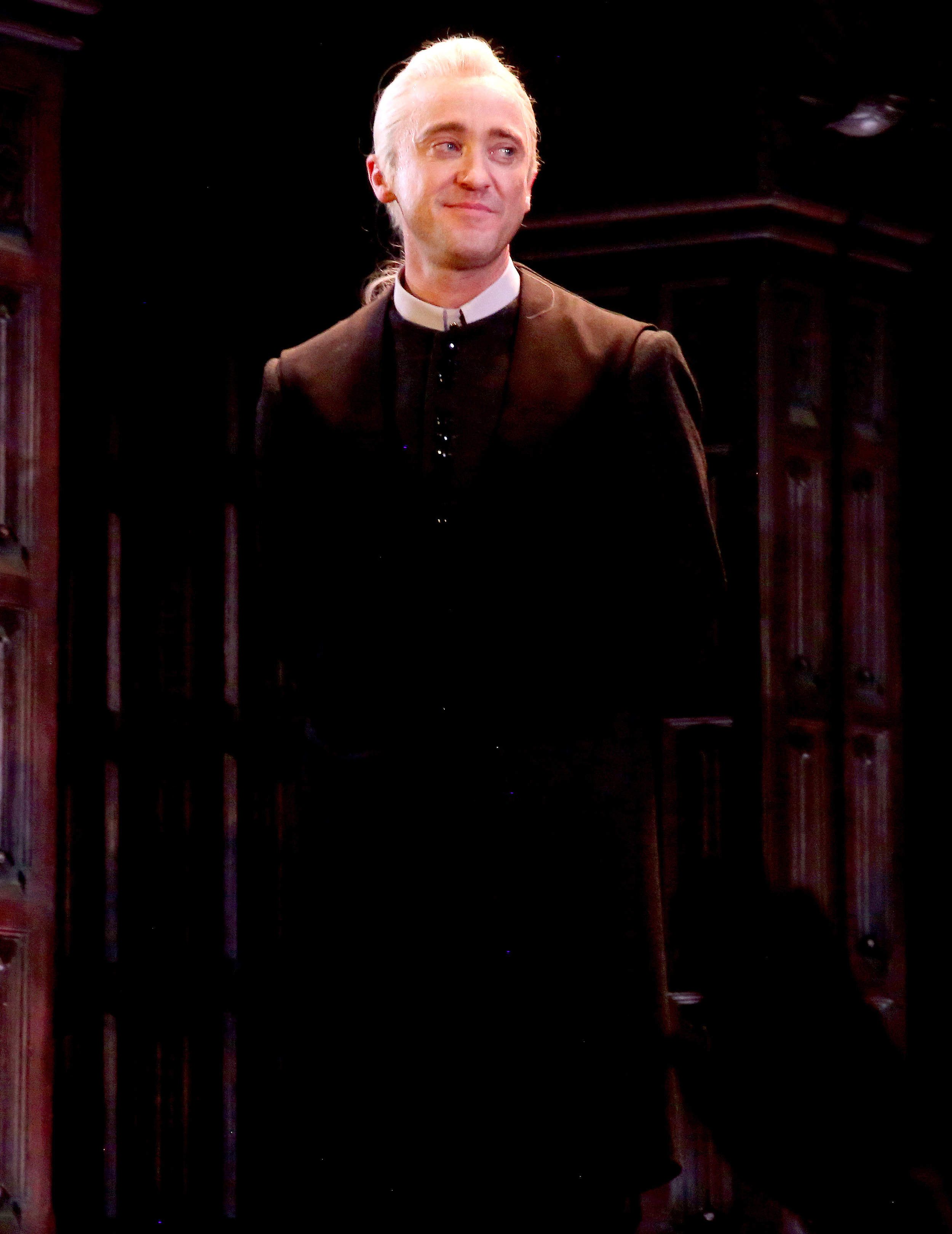 Tom Felton takes his first Broadway bow as Draco Malfoy, standing in the glow of the Lyric Theatre with a proud, quiet smile. Dressed in character's dark robes, he carries the gravity of the role with a newfound stage presence. The moment marks a triumphant debut, blending nostalgia with a fresh chapter in the wizarding world.