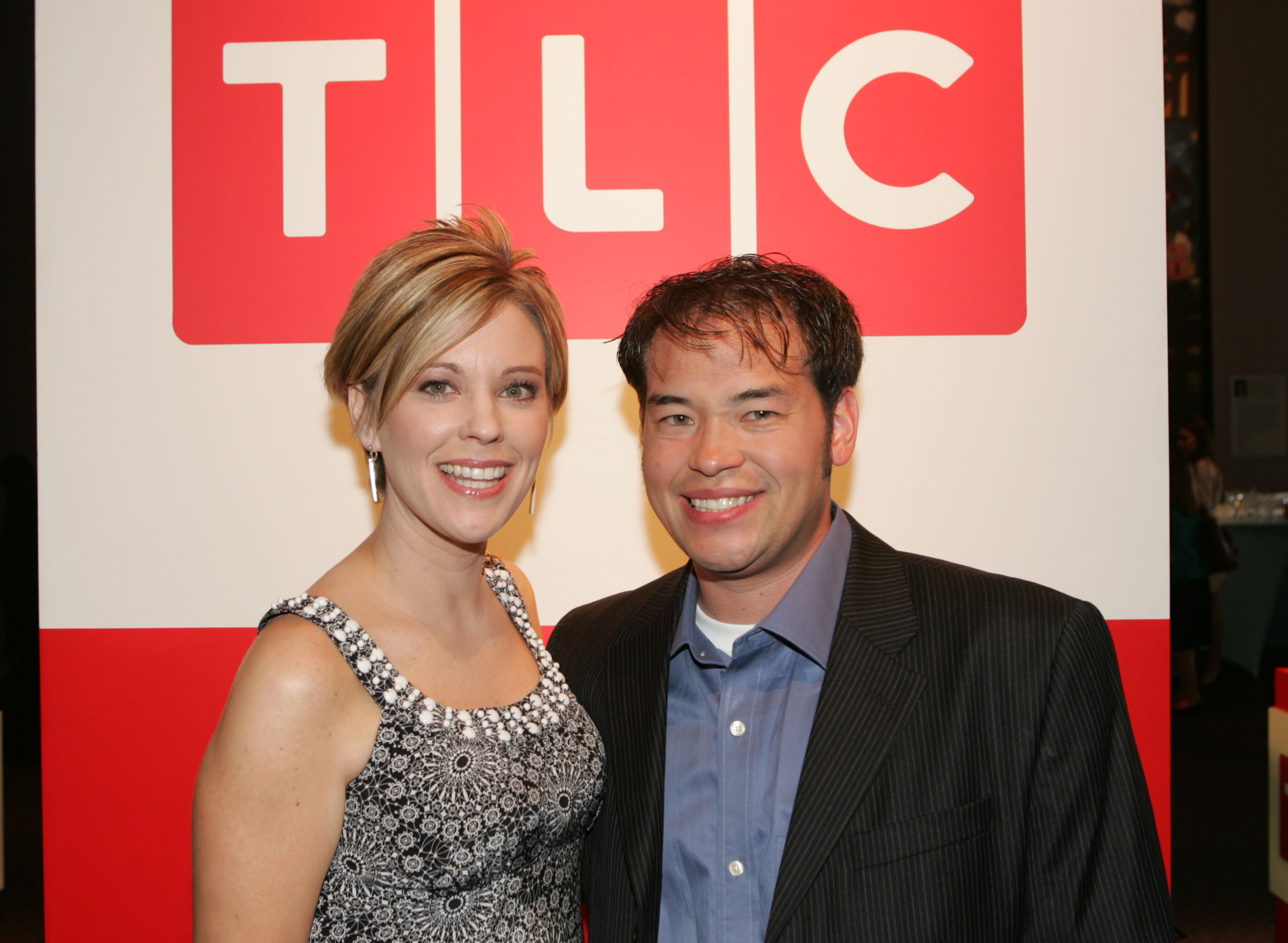At the Discovery Upfront in New York City, Kate Gosselin wore a black-and-white beaded dress and her signature short layered bob, posing with Jon Gosselin in front of a TLC backdrop during their peak "Jon & Kate Plus 8" fame.