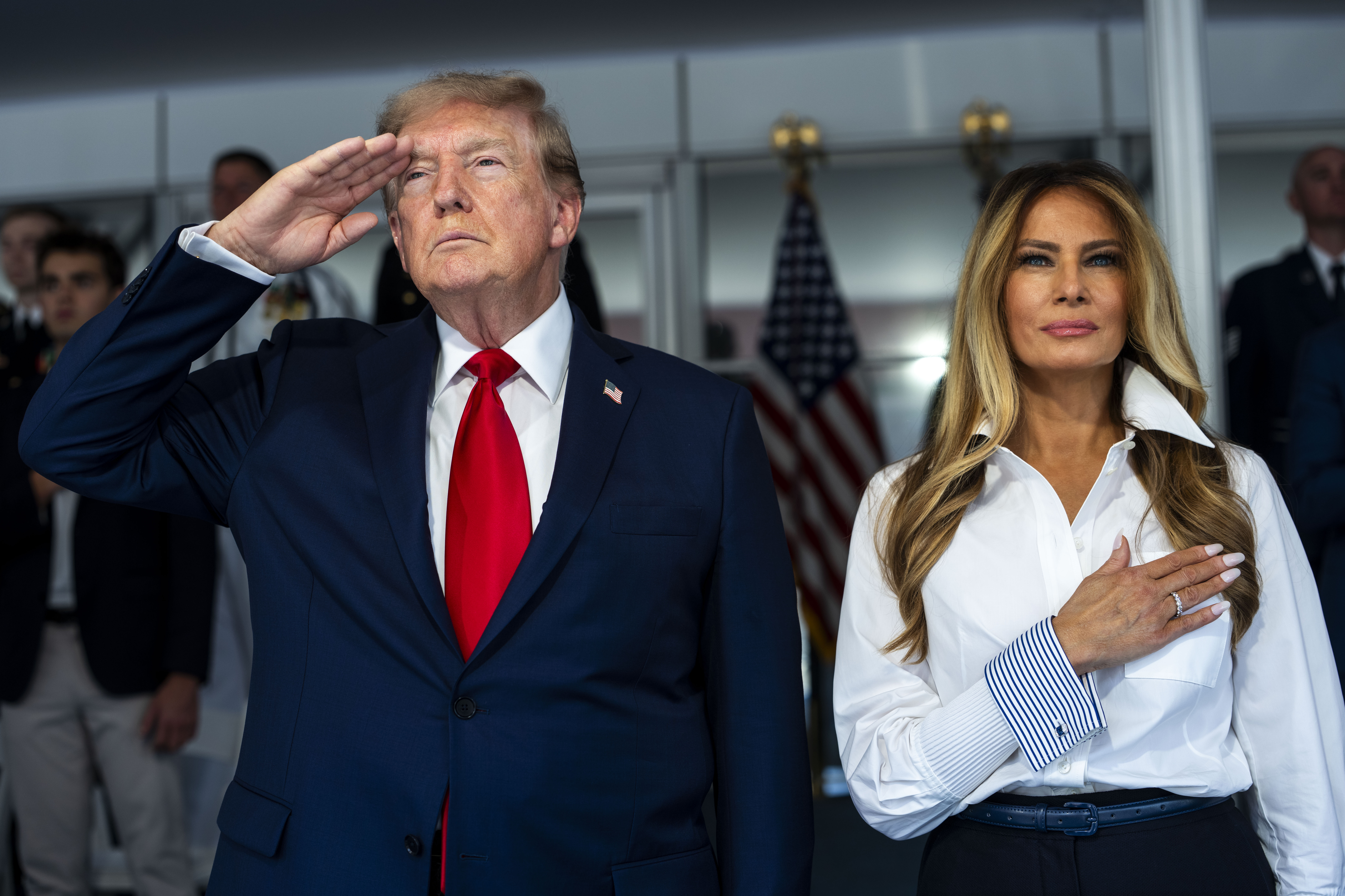 Some users thought they were press-ons, while others commented that they were too big. In this photo, Donald Trump and Melania Trump stood during the National Anthem at the start of the NTT INDYCAR Series Freedom 250 on August 23, 2026, in Washington, D.C. | Source: Getty Images