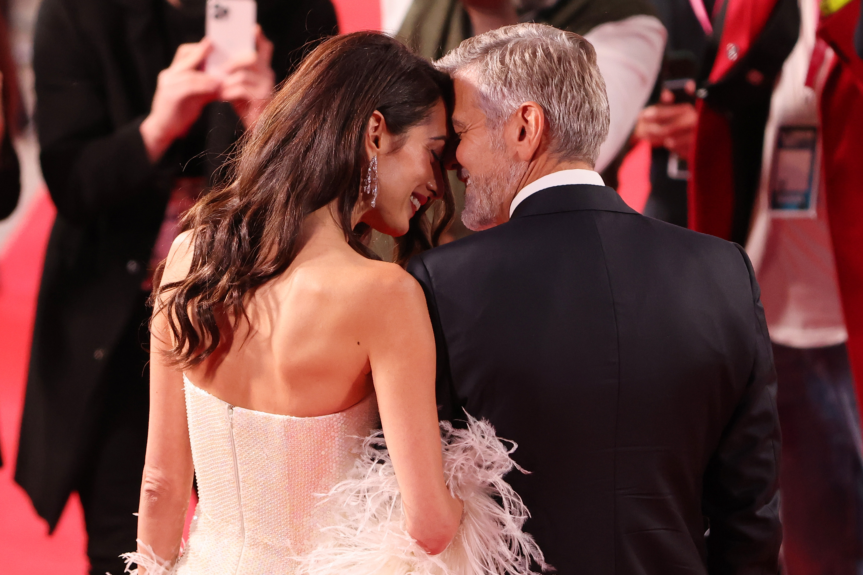 The Clooneys share a lighthearted moment at the premiere of The Tender Bar during the 65th BFI London Film Festival. Held at the Royal Festival Hall in London on October 10, 2021, the event highlighted George’s role as director and Amal’s steady support on the red carpet.