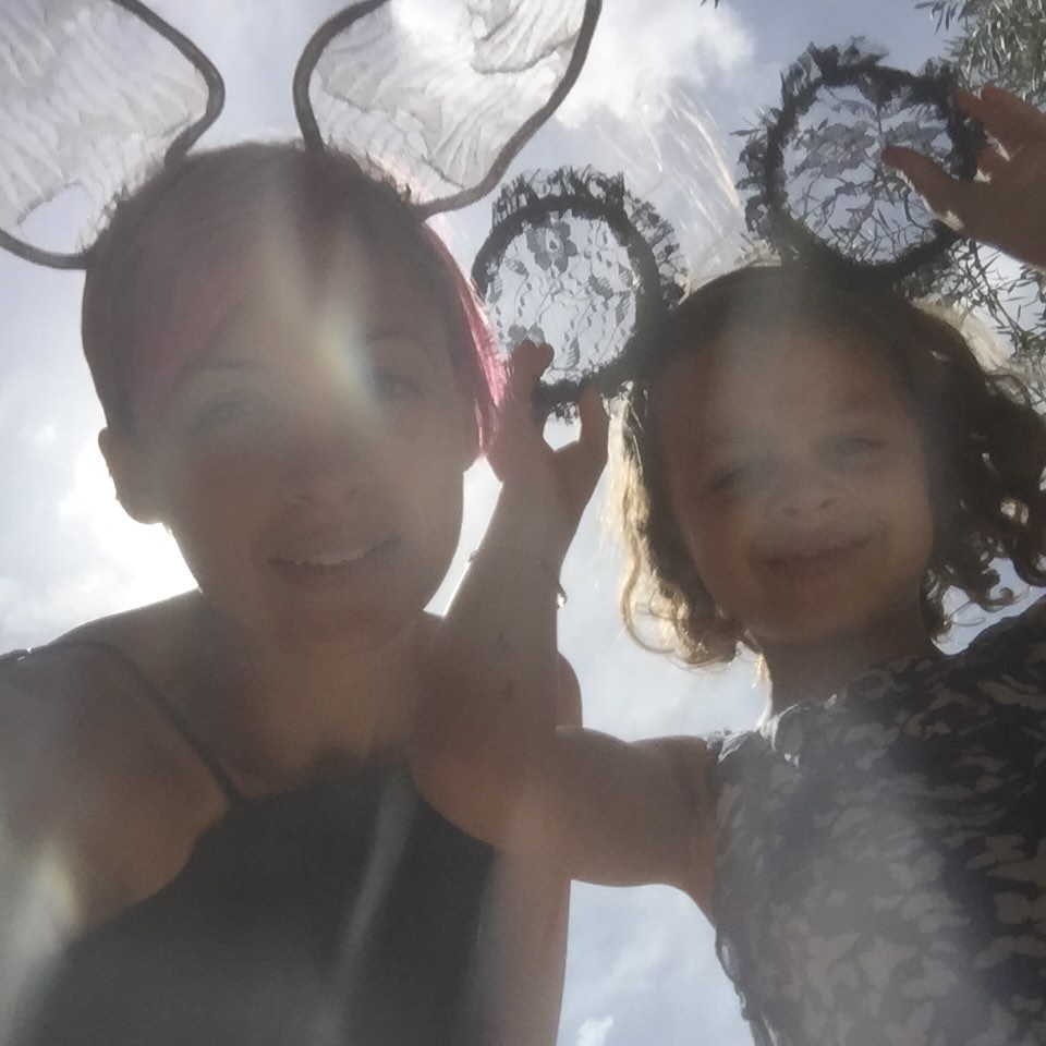 Nicole Richie and Harlow Winter Kate Madden wear playful headpieces while posing under bright sunlight. The low-angle photo captures a carefree mother-daughter moment, with Kate smiling beside her mother outdoors. | Source: Instagram/nicolerichie and joelmadden