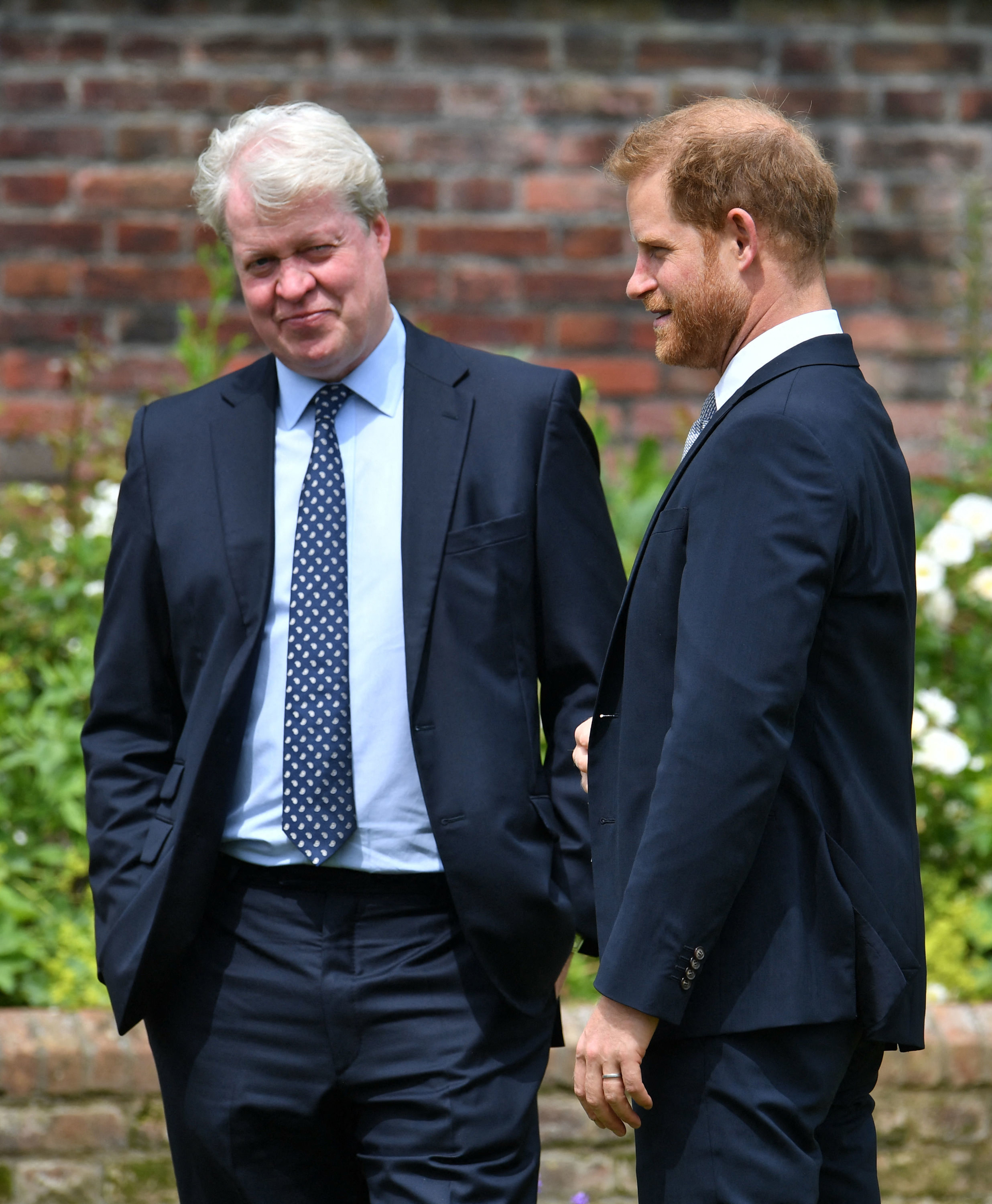 Prince Harry chats with his uncle Earl Spencer at Kensington Palace ahead of the unveiling of a statue of his late mother, Princess Diana, on July 1, 2021 | Source: Getty Images