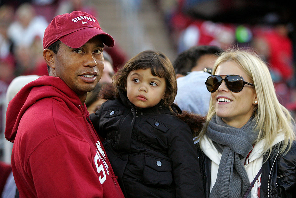 Tiger Woods holds Sam Woods and stands next to Elin Nordegren on the sidelines before the Stanford Cardinal game against the California Bears at Stanford Stadium on November 21, 2009, in Palo Alto, California | Source: Getty Images