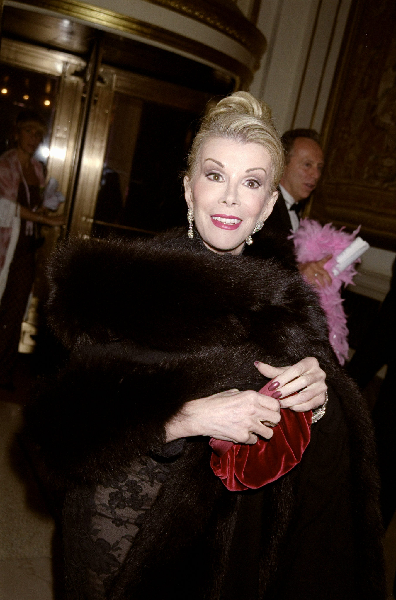 Joan Rivers arrives at the Pink and Black Ball at New York City's Plaza Hotel on October 13, 1999, as her public appearances continued to document the look she openly acknowledged changing through cosmetic procedures. | Source: Getty Images