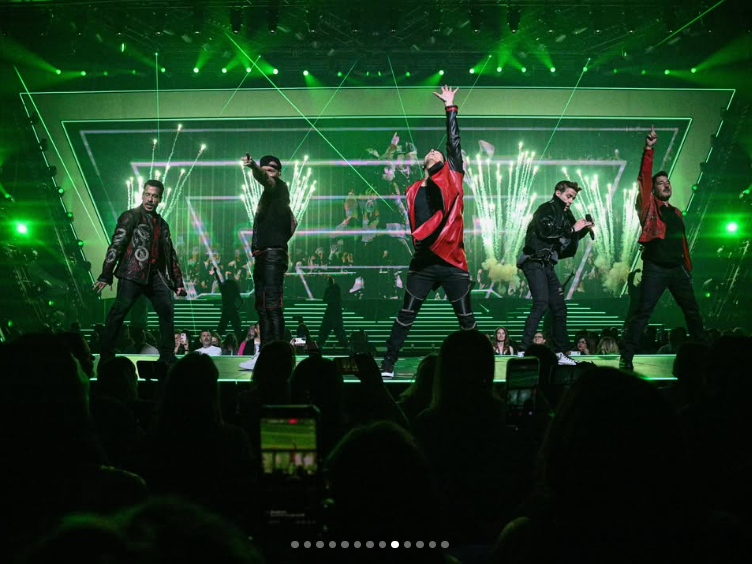 New Kids on the Block perform beneath green lights and pyrotechnics during their "The Right Stuff" Las Vegas residency. The production featured elaborate staging and visual effects designed for the Dolby Live venue, where the band had scheduled 24 performances throughout 2026. | Source: Instagram/nkotb