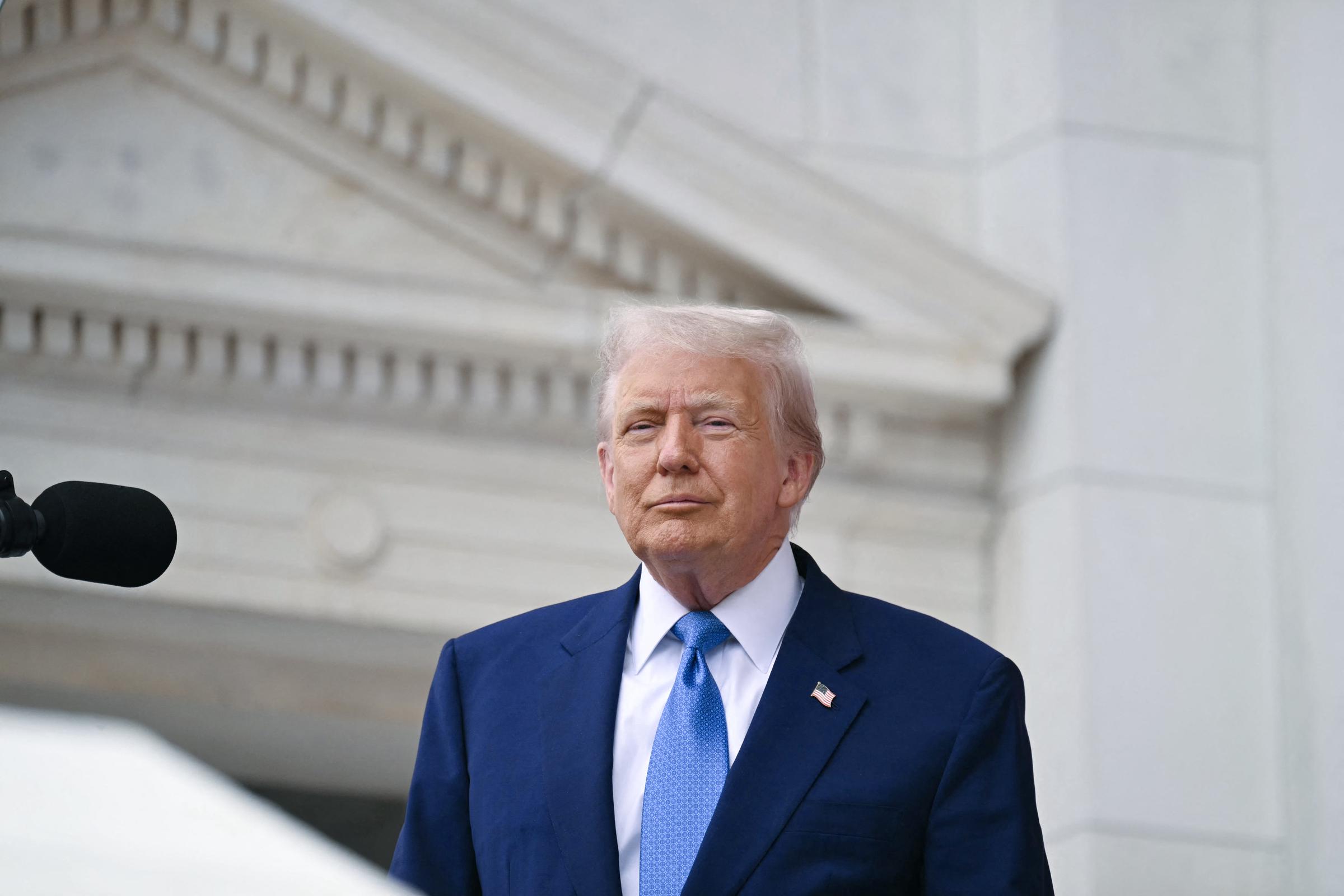 President Donald Trump arrives to deliver remarks at the National Memorial Day Observance at the Memorial Amphitheatre in Arlington National Cemetery on May 26, 2025, in Arlington, Virginia. | Source: Getty Images