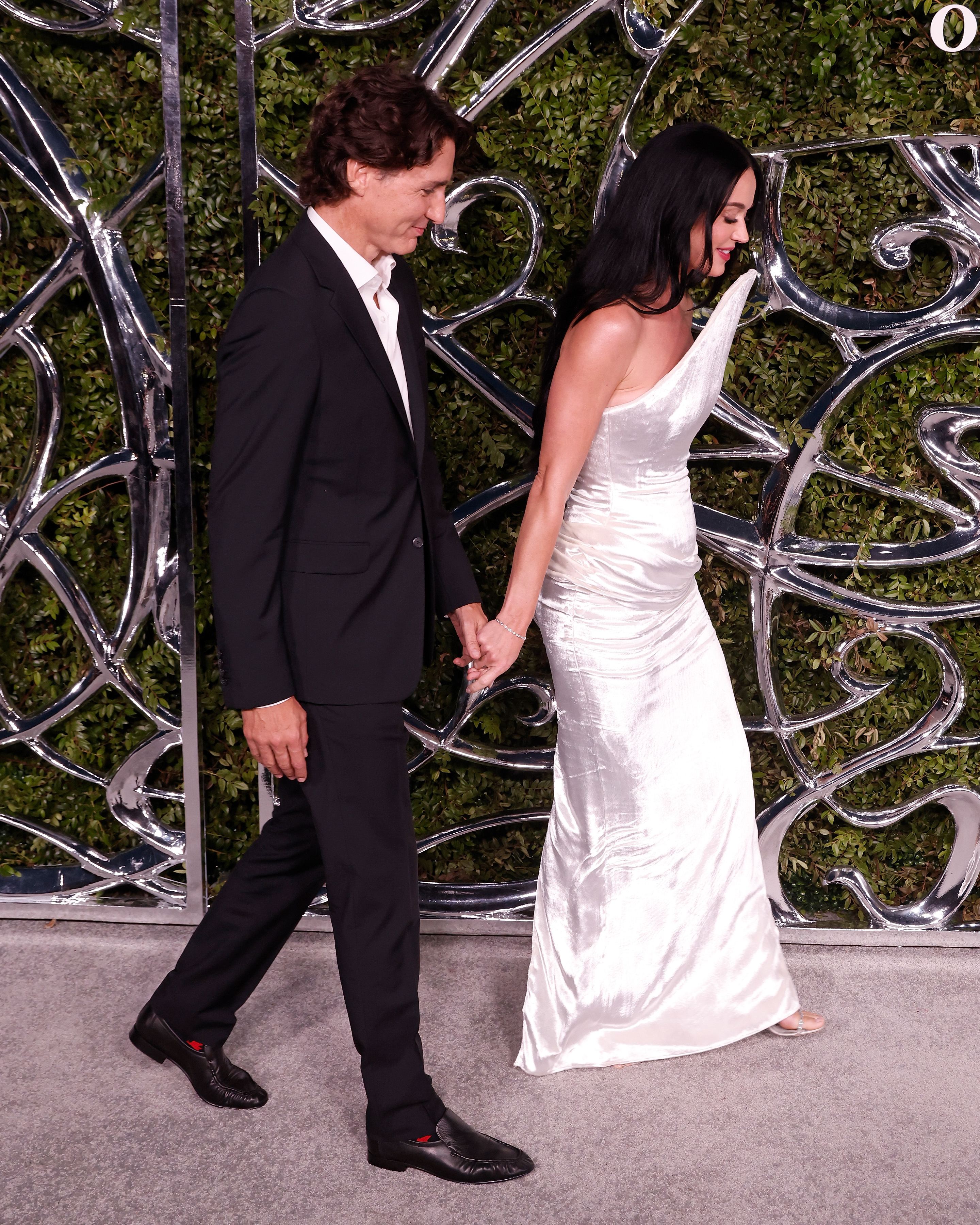 A wider frame captured Perry and Trudeau holding hands as they walked together. The image completed a sequence that moved from a formal pose to increasingly candid moments between the pair. | Source: Getty Images