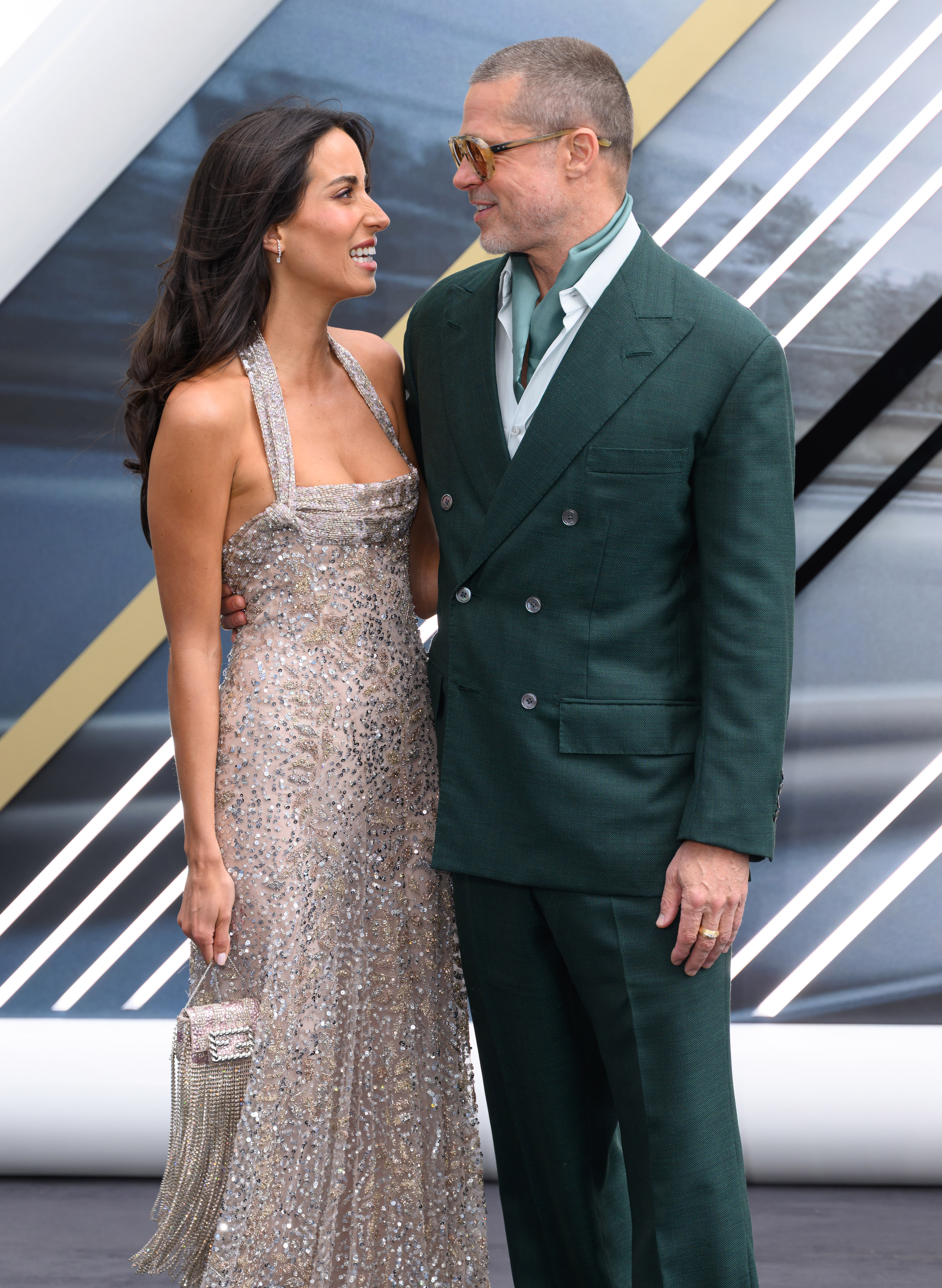 Ines de Ramon and Brad Pitt share a smile and pose arm-in-arm on the red carpet at the "F1: The Movie" premiere | Source: Getty Images