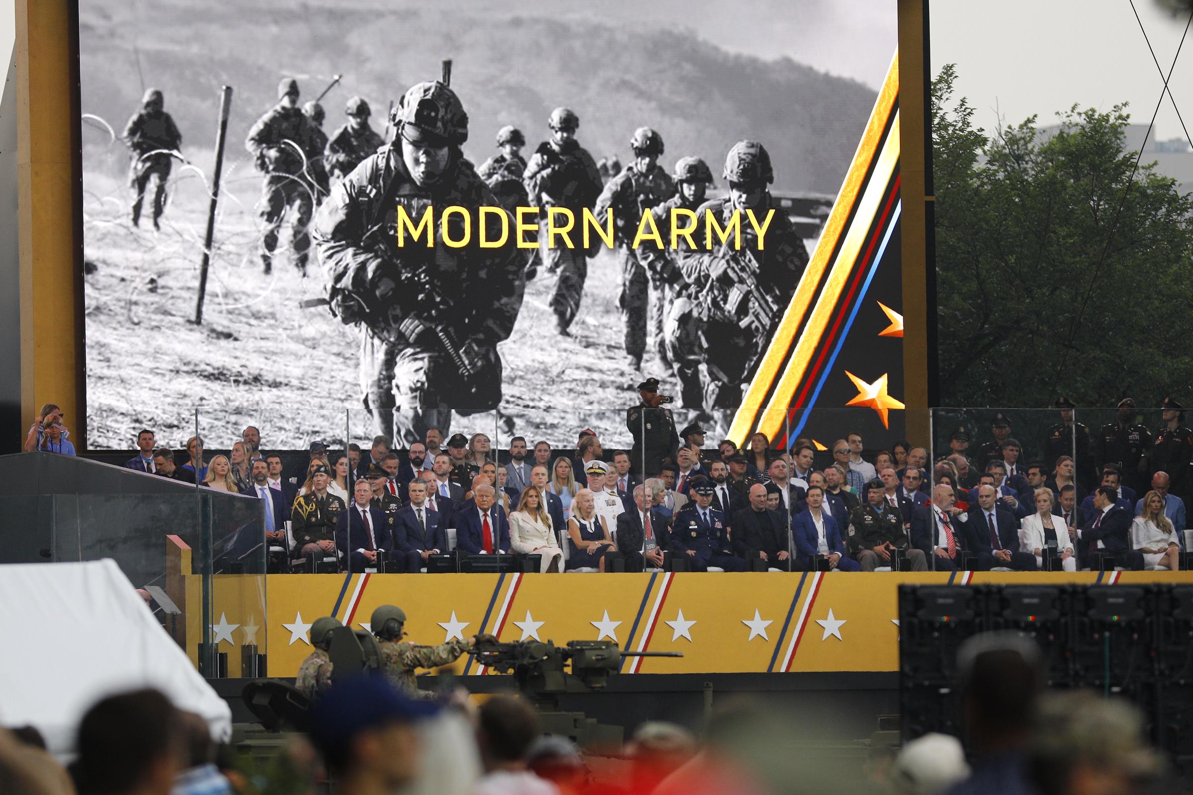Daniel Driscoll, secretary of the Army, left, Pete Hegseth, Secretary of defense, Donald, and Melania Trump watch during the U.S. Army's 250th birthday parade | Source: Getty Images