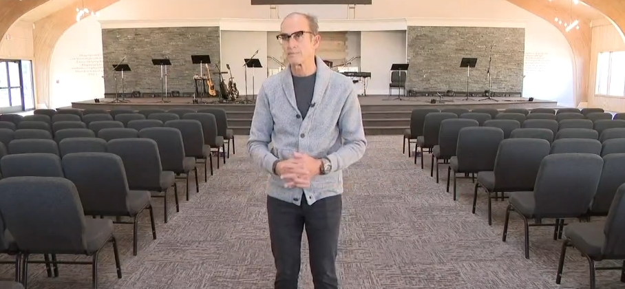Church pastor Nicholas DeJacimo stood between orderly rows of chairs inside Living Word Sanctuary Church's completed worship space, with musical instruments, lecterns, screens, and a broad stage visible behind him. The finished room demonstrated how thoroughly Mike Tyson's former mansion had been repurposed, exchanging the signs of prolonged abandonment for an organized sanctuary designed around the needs and activities of the congregation now occupying the property. | Source: YouTube/WKYC Channel 3