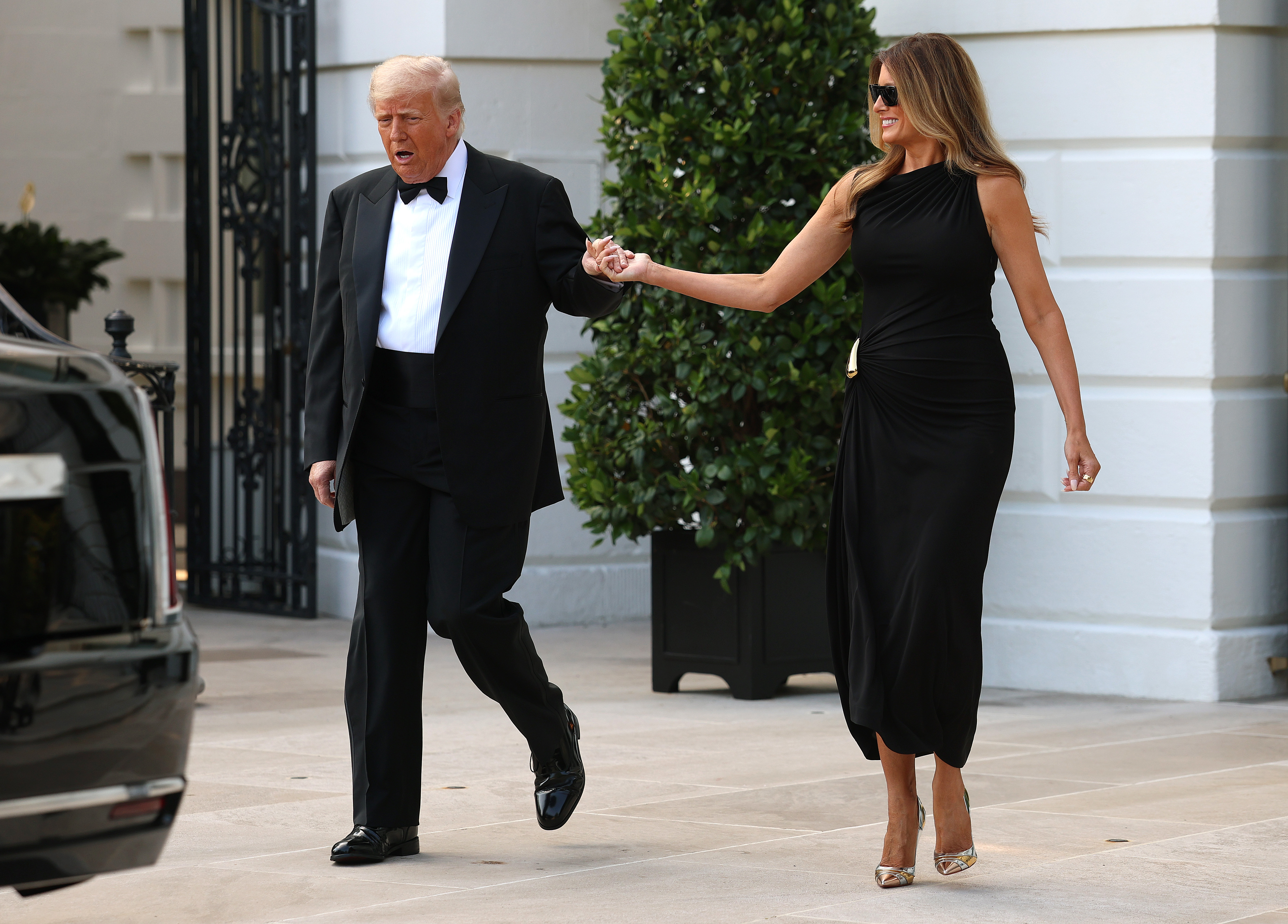 With smiles and clasped hands, the president and first lady make their way toward a waiting vehicle outside the White House on June 11, 2025, capturing a rare moment of ease ahead of the evening's public engagement.