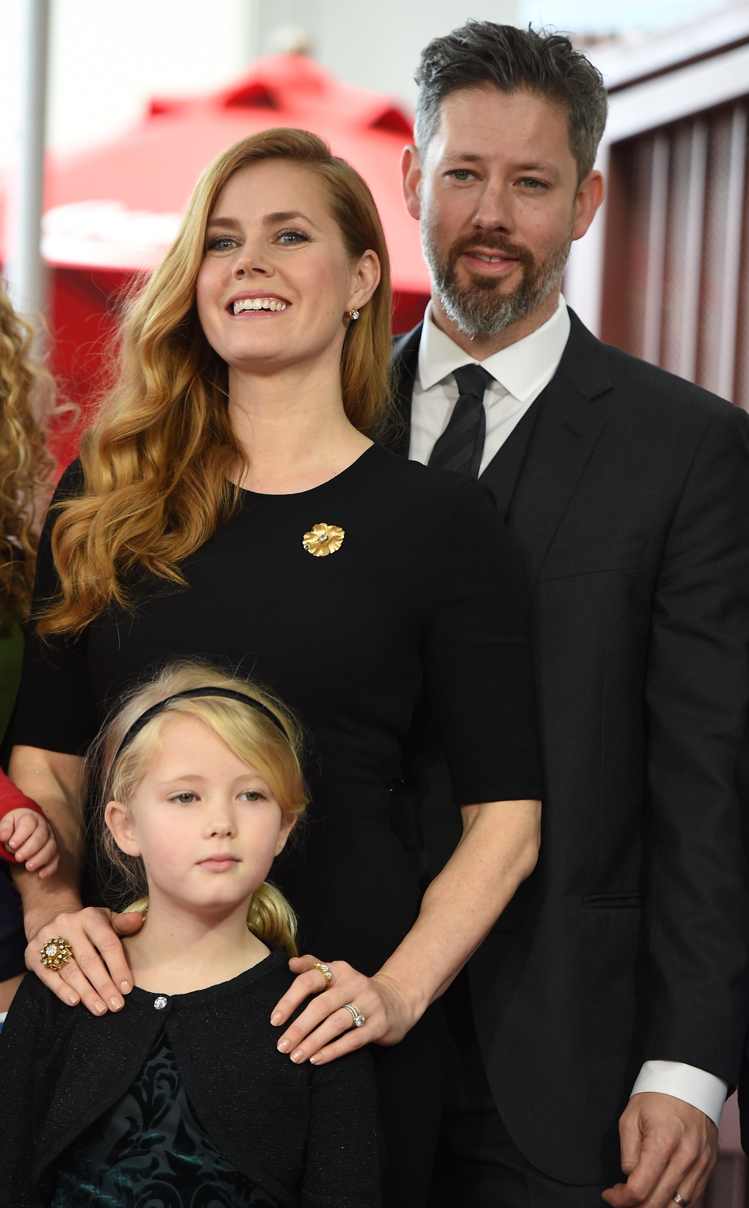 Amy Adams stands with Darren Le Gallo and their daughter, Aviana Olea Le Gallo, during Amy's Hollywood Walk of Fame celebration. The family poses together as Amy marks the career milestone.