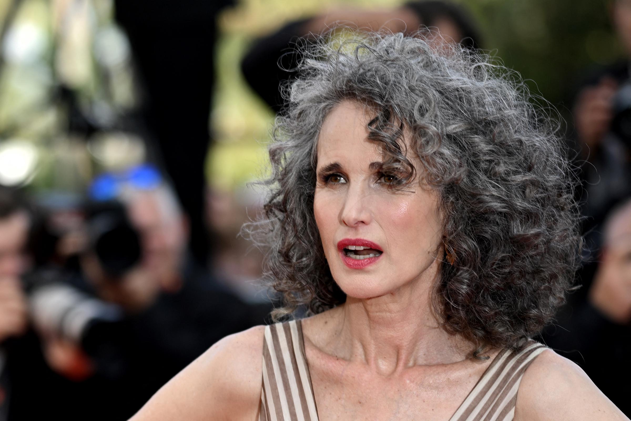 Andie MacDowell proudly shows off her natural gray curls at the 2022 Cannes Film Festival in France. Her salt-and-pepper hair became part of her signature look after she decided to stop dyeing it during the COVID-19 lockdown.