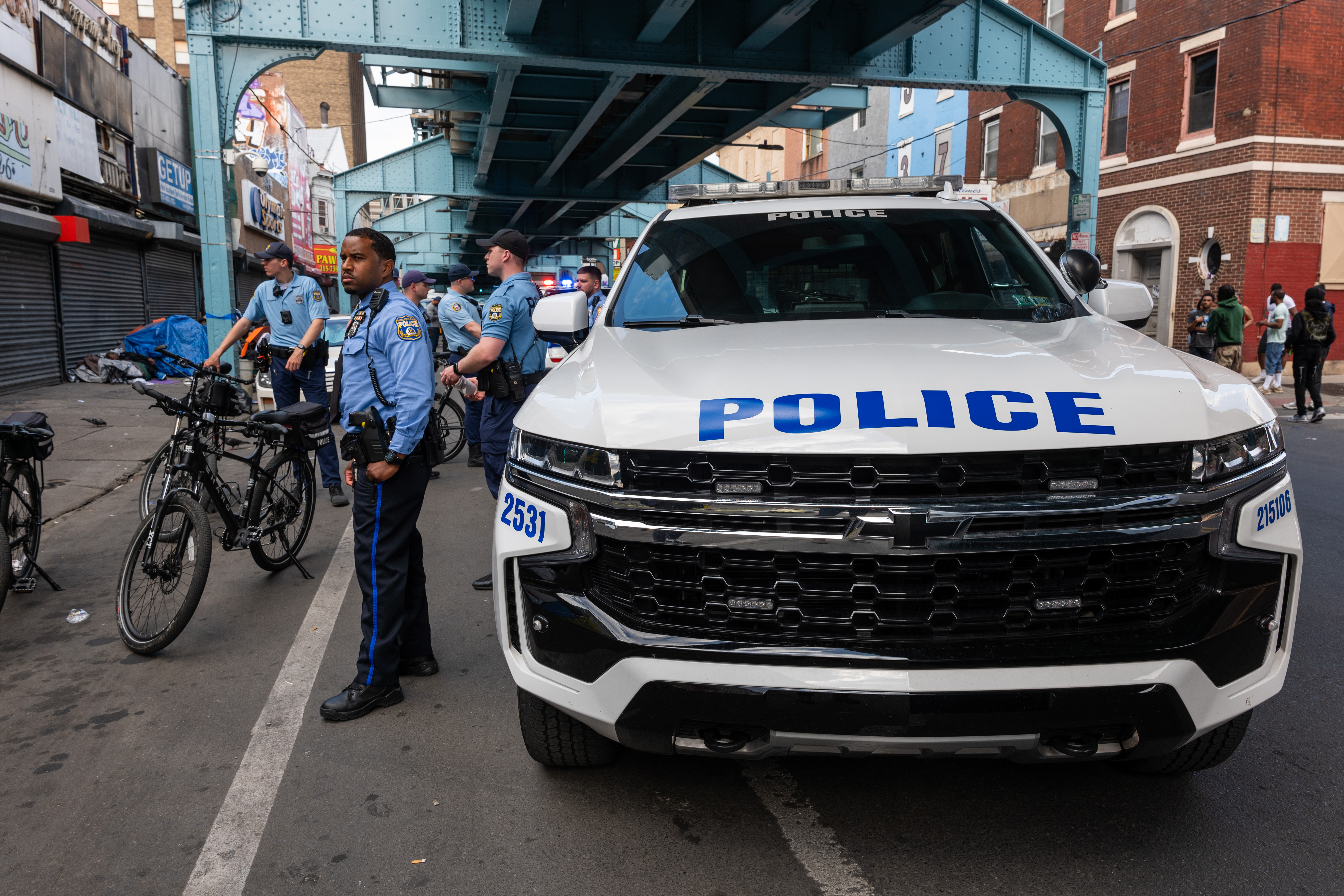 Police officers stand near a patrol vehicle on a city street (illustration purposes only) | Source: Getty Images