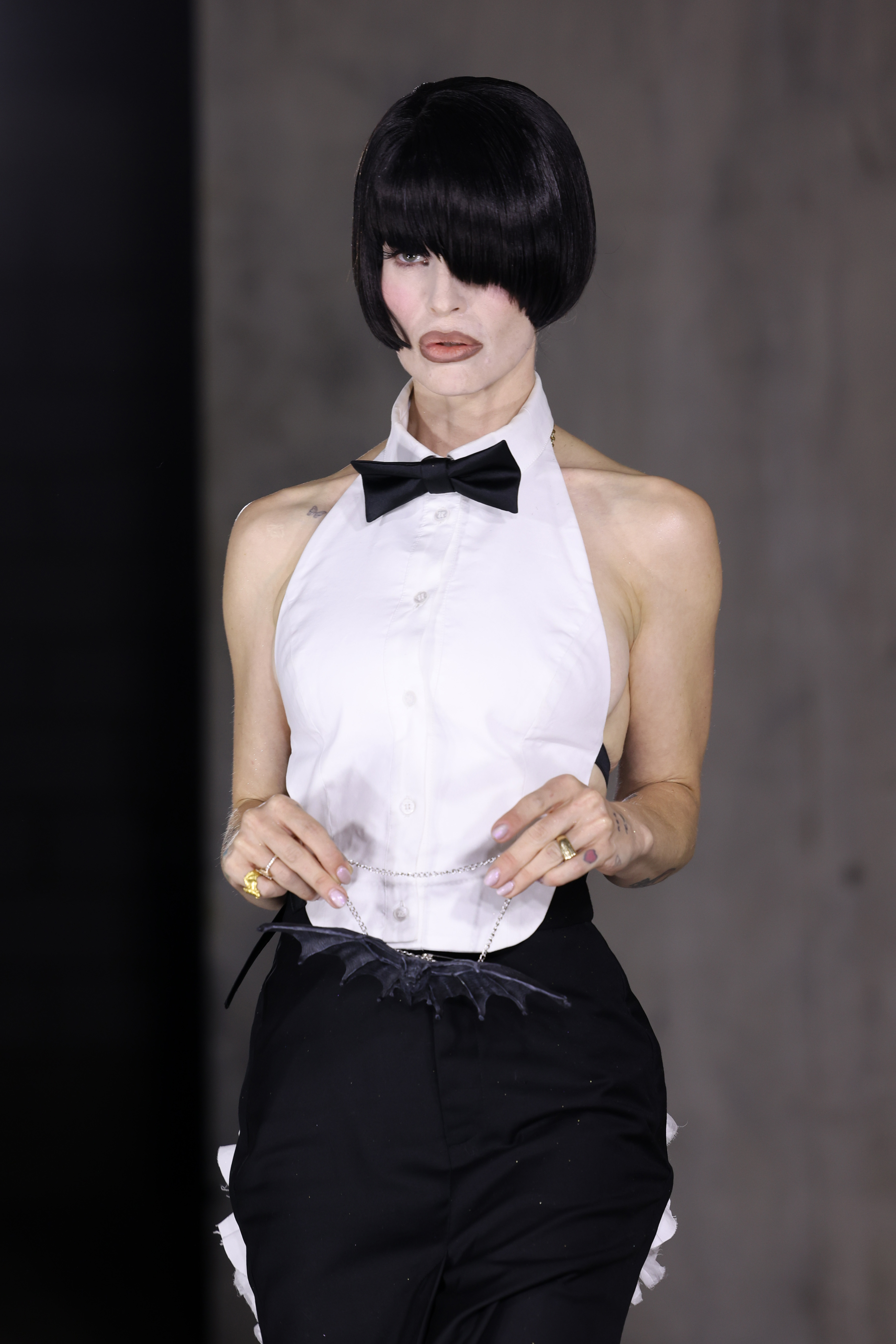 Kelly Osbourne walks the runway at Natasha Zinko's Spring/Summer 2027 show during London Fashion Week on September 18, 2026, wearing a jet-black bob wig and a black-and-white ensemble. | Source: Getty Images
