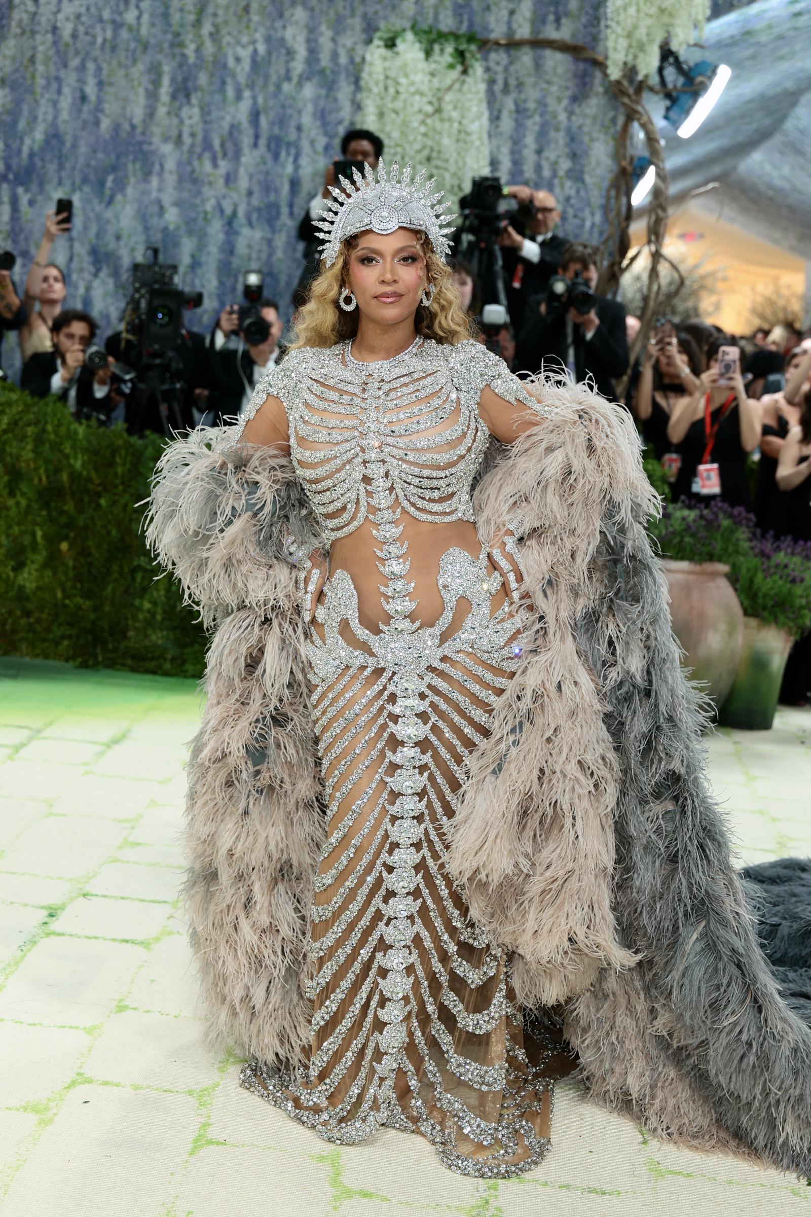 Beyoncé faces the cameras in her sheer gown with bone-like silver detailing | Source: Getty Images