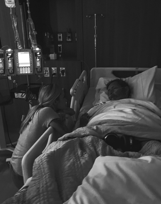 Shay Thomas stays close to her father as he rests beneath blankets in a hospital bed. Although she had not planned to share another update, his condition prompted her to ask supporters to keep him in their prayers. | Source: Instagram/mrs__shay