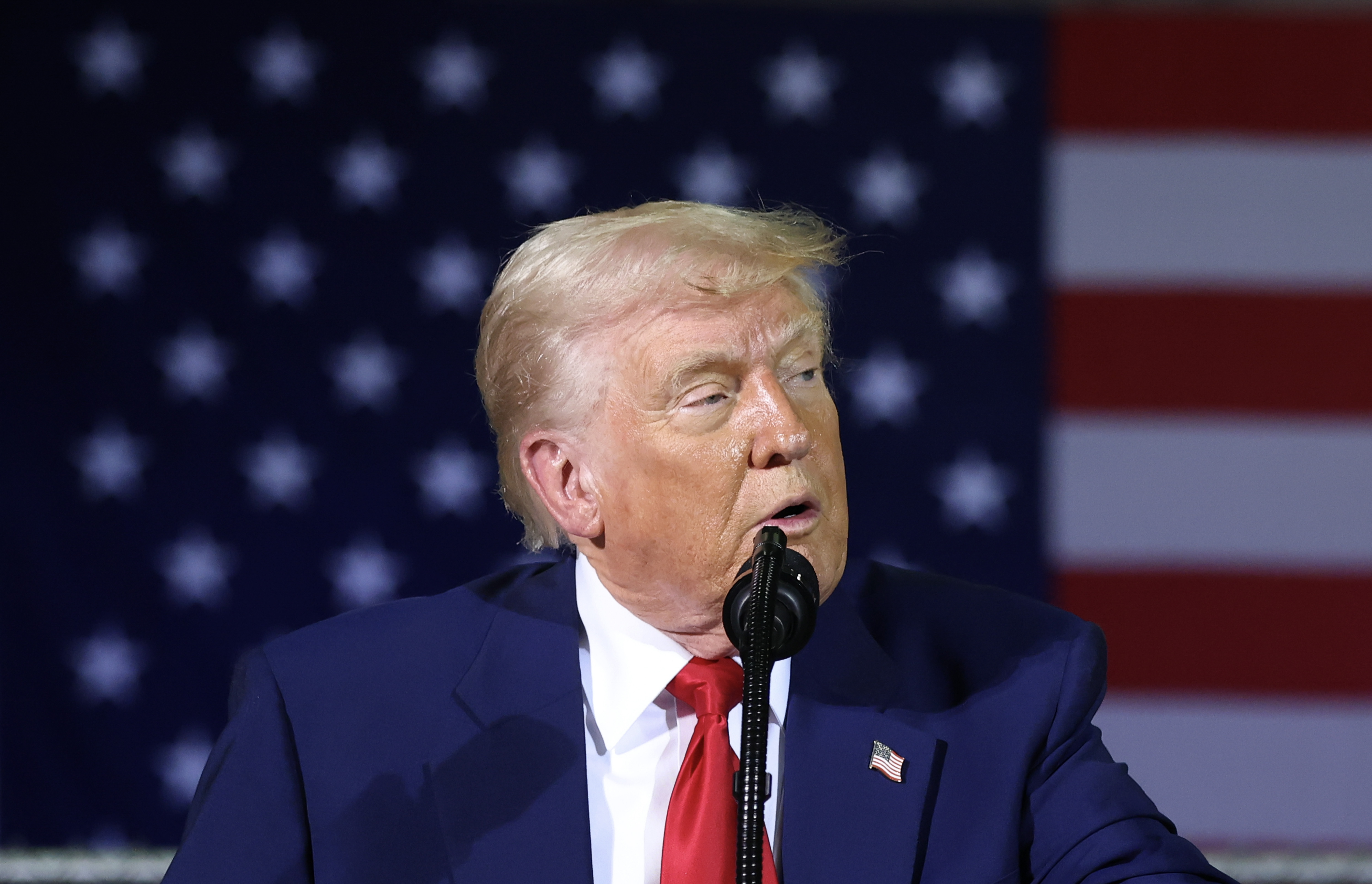 Donald Trump speaking during a visit with Michigan Air National Guard troops in Michigan on April 29, 2025. | Source: Getty Images