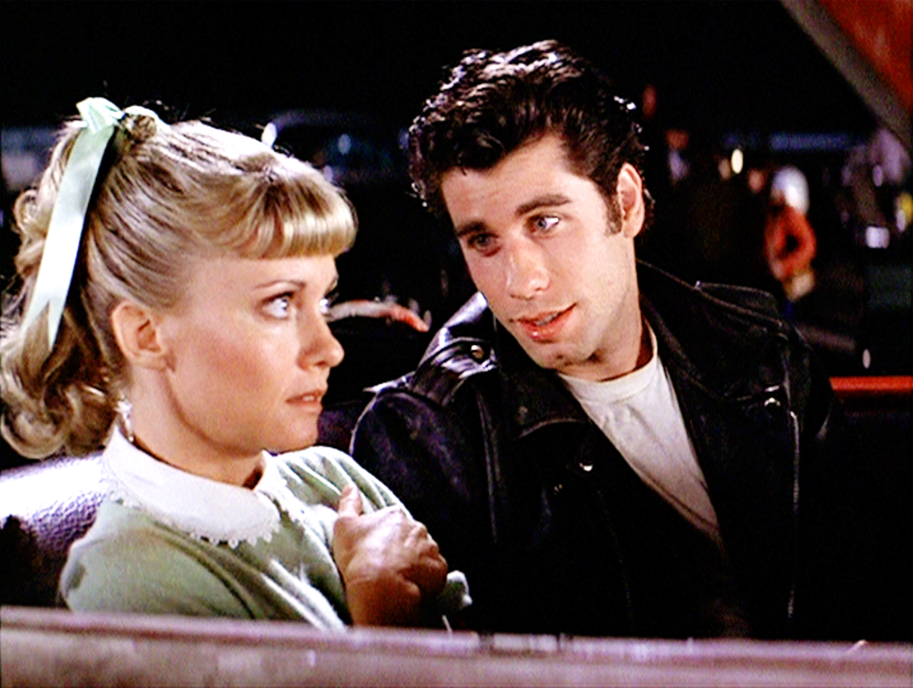 Sandy looking on as Danny stares at her. | Source: Getty Images