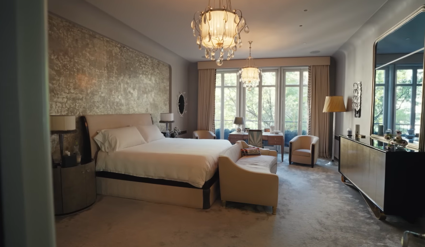 The bedroom has the polish of a luxury hotel suite, which was exactly the intention. Personal objects and seating areas keep it from feeling anonymous. | Source: YouTube/Architectural Digest