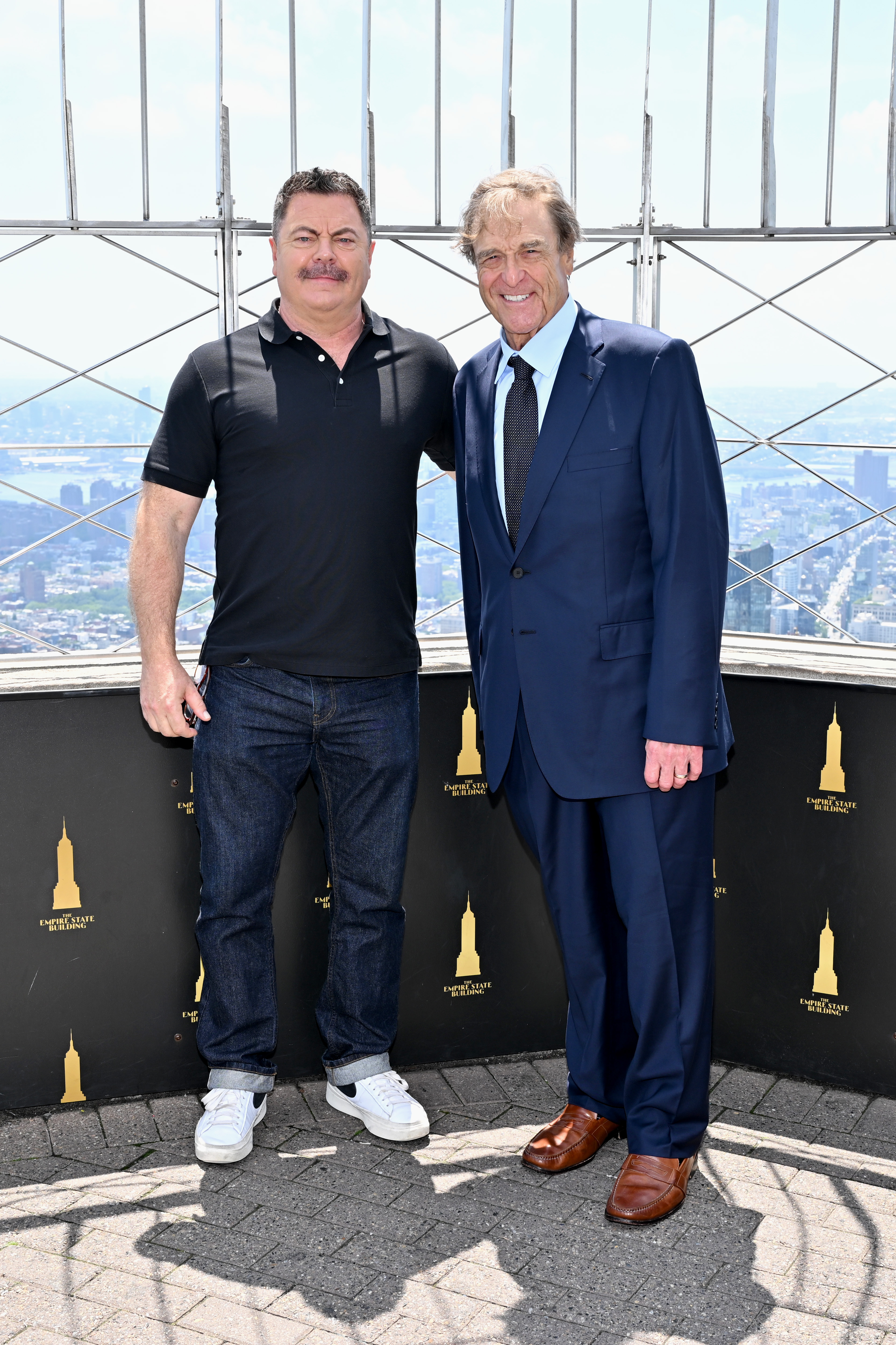 John Goodman joins Nick Offerman at the Empire State Building on July 16, 2025, while celebrating the premiere of "Smurfs" with the Lollipop Theater Network. | Source: Getty Images