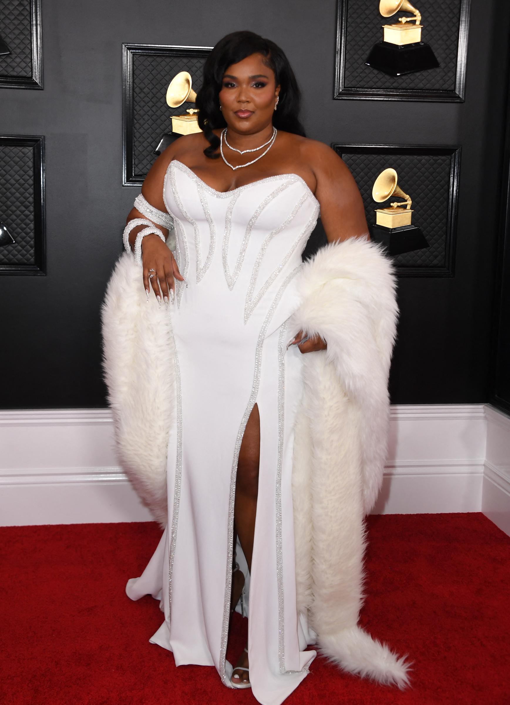 Arriving at the Grammys, Lizzo exudes elegance and confidence, her poised stance reflecting a career at its peak. Draped in a glamorous white ensemble, the moment captures her full arrival — where talent, recognition, and star power meet.