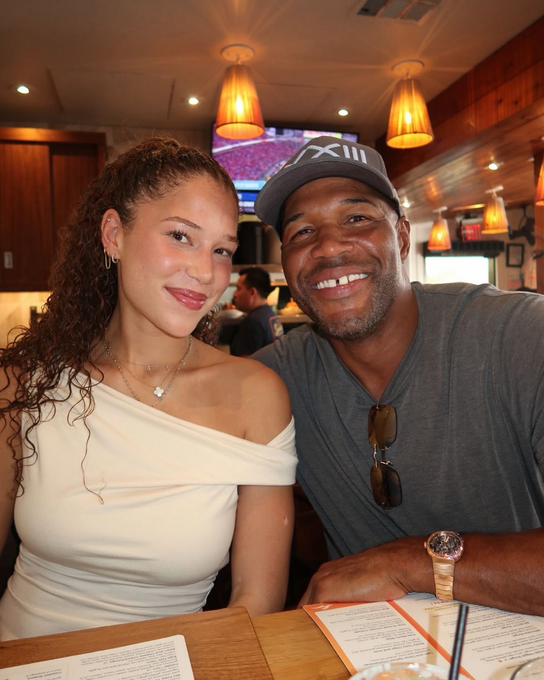 Michael Strahan beams beside one of his daughters during a casual outing, reflecting the close father-daughter bond celebrated in his birthday tribute. | Source: Instagram/michaelstrahan
