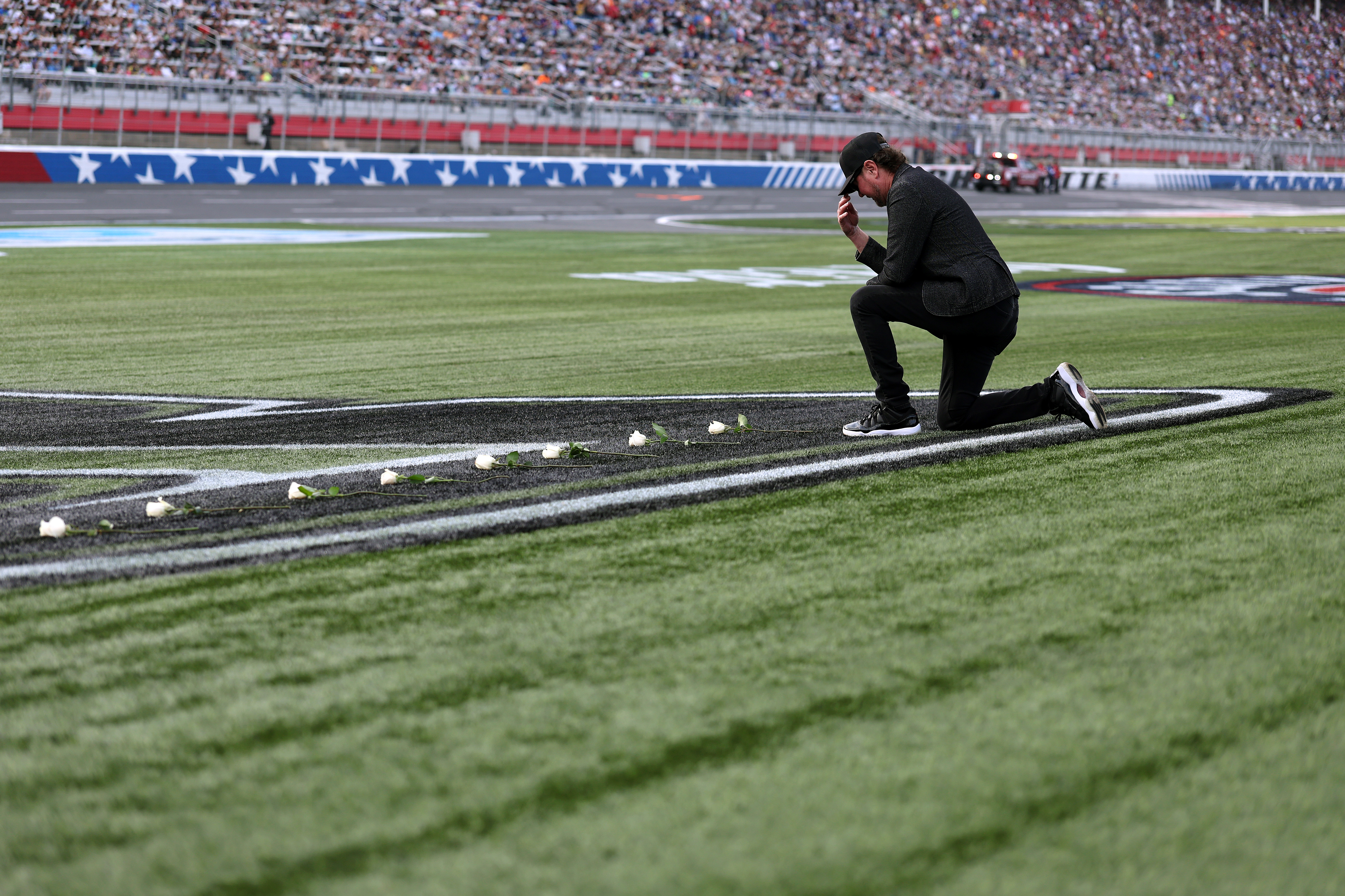 Kurt Busch places white roses on the No. 8 logo during a tribute ceremony for his brother Kyle Busch before the Coca-Cola 600 at Charlotte Motor Speedway in Concord, North Carolina, on May 24, 2026 | Source: Getty Images